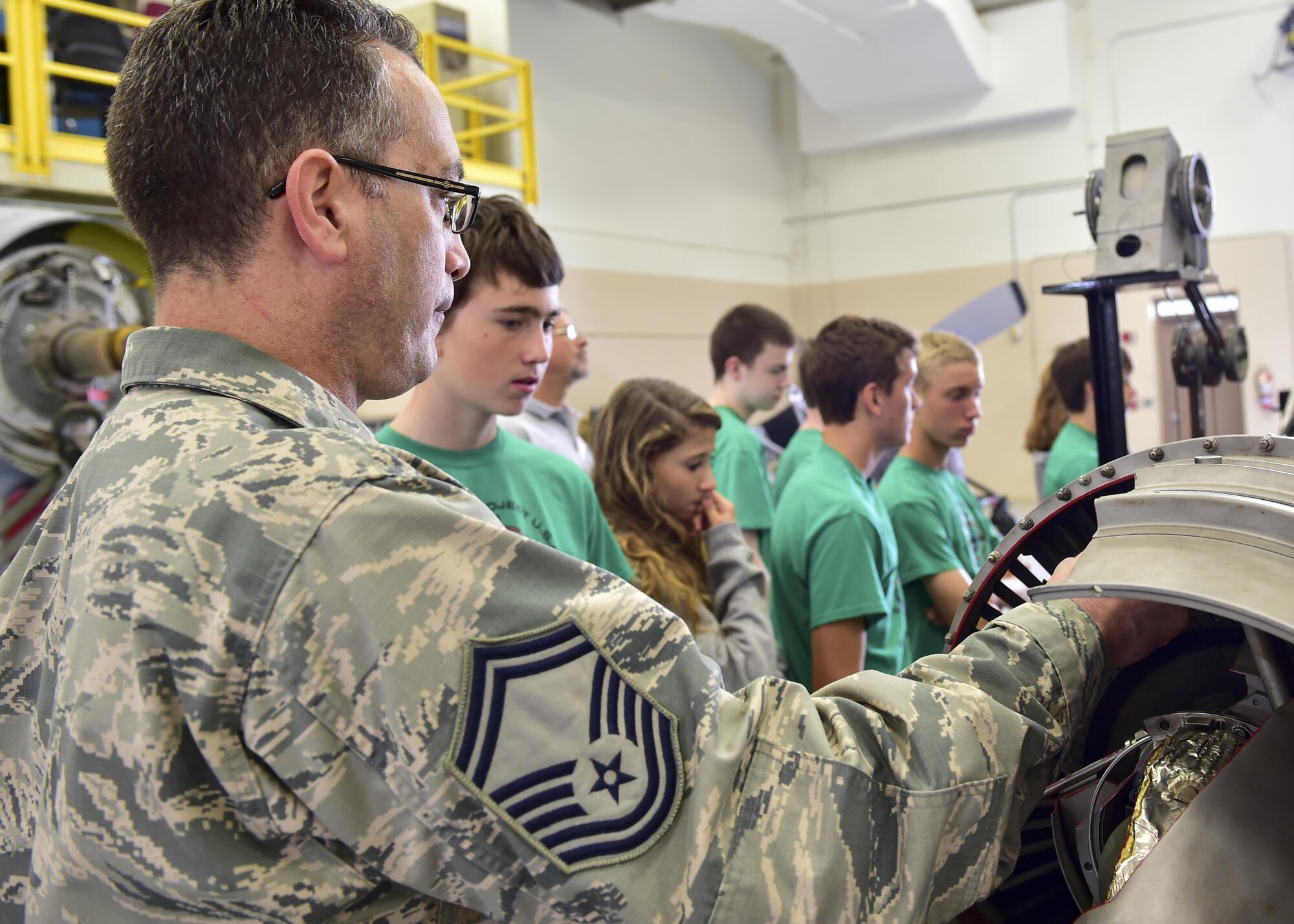 Senior Master Sgt. Bob Pierce, aerospace propulstion superintendent with the 910th Maintenance Squadron, exhibits a cutaway C-130H Hercules aircraft during a tour here, July 10, 2015. The Alliance Ulster Project, which exists to promote unity between Roman Catholics and Protestants, brought a group of U.S. and Irish teenagers to tour Youngstown Air Reserve Station as part of their summer program. U.S. Air Force photo/Eric M. White