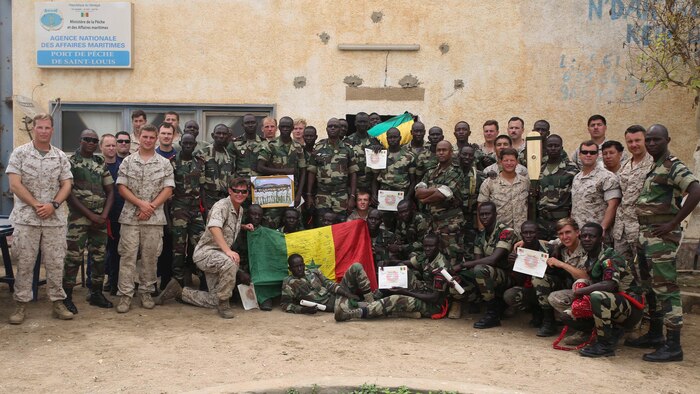 Marines, sailors and coast guardsmen assigned to Special-Purpose Marine Air-Ground Task Force Crisis Response-Africa and members of the Compagnie Fusilier de Marin Commandos pose for a picture after a graduation ceremony in St. Louis, Senegal, July 9, 2015. More than 30 members of the Fusilier Marins graduated a nearly six-week long maritime security force assistance training course, where the U.S. service members taught the Senegalese small-boat operations and light infantry skills. 