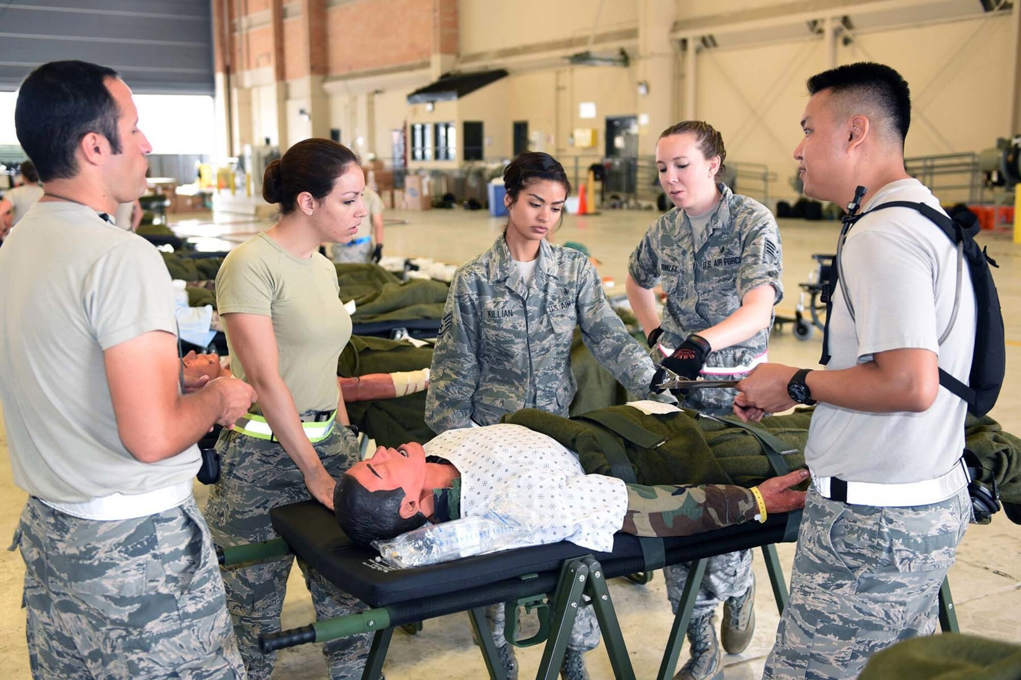 Airmen from the 59th Medical Wing, Joint Base San Antonio-Lackland, Texas, discuss a simulated patient's care during aeromedical evacuation processing in an Ultimate Caduceus 2015 exercise at Naval Air Station Joint Reserve Base New Orleans, La., April 16, 2015. Ultimate Caduceus 2015 consists of approximately 140 military personnel representing active duty, National Guard and Reserve forces from California, Delaware, Illinois, Kansas, Louisiana, Maryland, Mississippi, Texas and Washington, D.C. (U.S. Air National Guard Photo by Master Sgt. Dan Farrell, 159th Fighter Wing Public Affairs Office/Released)