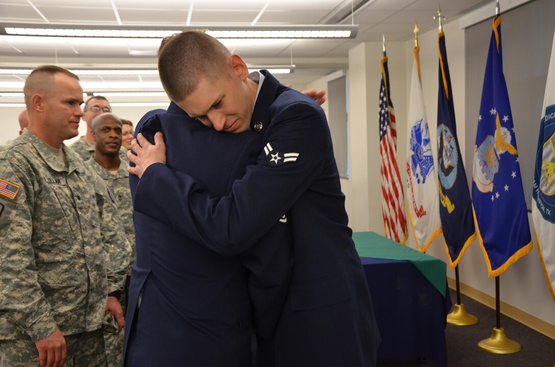 Airman Christian Frizzell, a student at the Medical Education and Training Campus, receives a hug from his father, Chief Master Sgt. Charles Frizzell, following his Biomedical Equipment Technician (BMET) class graduation ceremony April 10. Airman Frizzell is starting his new career at Wright-Patterson Air Force Base, Ohio. His father, also a BMET, is currently assigned as the senior enlisted advisor to the commander at the 374th Medical Group at Yokota Air Base, Japan. (Photo by Lisa Braun) 