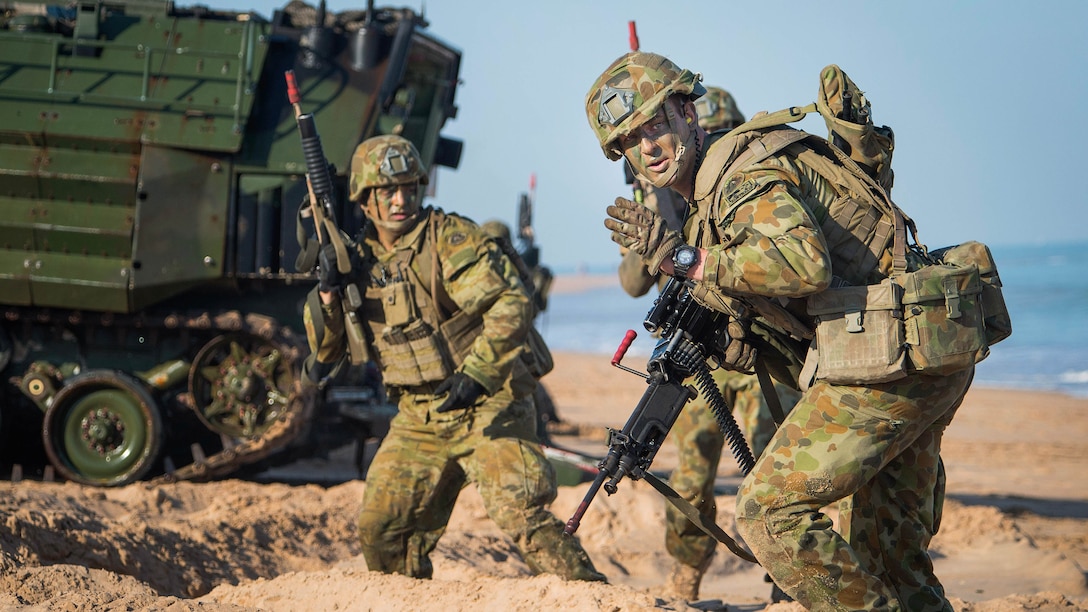 An Australian Army Soldier, assigned to 2nd Battalion, Royal Australian Regiment, motions to move forward during an amphibious assault for Talisman Sabre 2015 at Fog Bay, Australia, July 11, 2015. Talisman Sabre is a biennial exercise that provides an invaluable opportunity for nearly 30,000 U.S. and Australian defense forces to conduct operations in a combined, joint and interagency environment that will increase both countries’ ability to plan and execute a full range of operations from combat missions to humanitarian assistance efforts. 