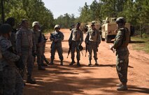 Airmen with the 1st Special Operations Civil Engineer Squadron  conduct a safety brief before convoy operations training begins on Eglin Range, Fla., July 2, 2015. The 1st SOCES conducted convoy training as preparation to repair or construct equipment and facilities outside the wire during deployments. (U.S. Air Force photo by Airman Kai White/Released)