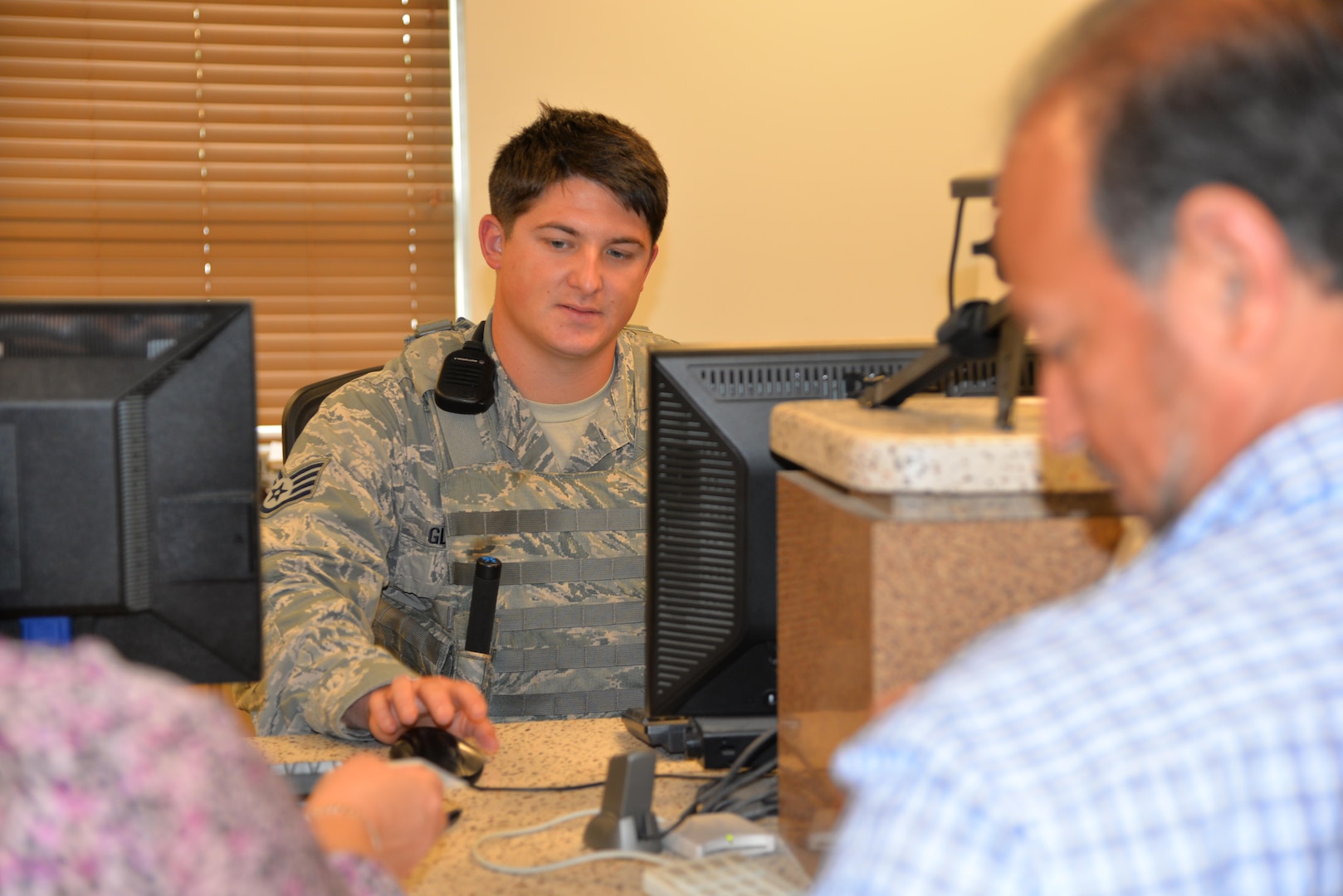 Staff Sgt. Kolton Glasoe, 502nd Security Forces Squadron entry controller, checks a visitor’s ID card at the Joint Base San Antonio-Fort Sam Houston Visitor Control Center. So far for 2015, the JBSA-Fort Sam Houston VCC has served nearly 16,000 customers. The Joint Base San Antonio-Fort Sam Houston Visitor Control Center is one of several facilities that play a vital first-defense role in the security of installation members, missions and assets across JBSA through a system that ensures those who could threaten that environment are denied base access. (U.S. Air Force photo by Steve Eliott/Released)