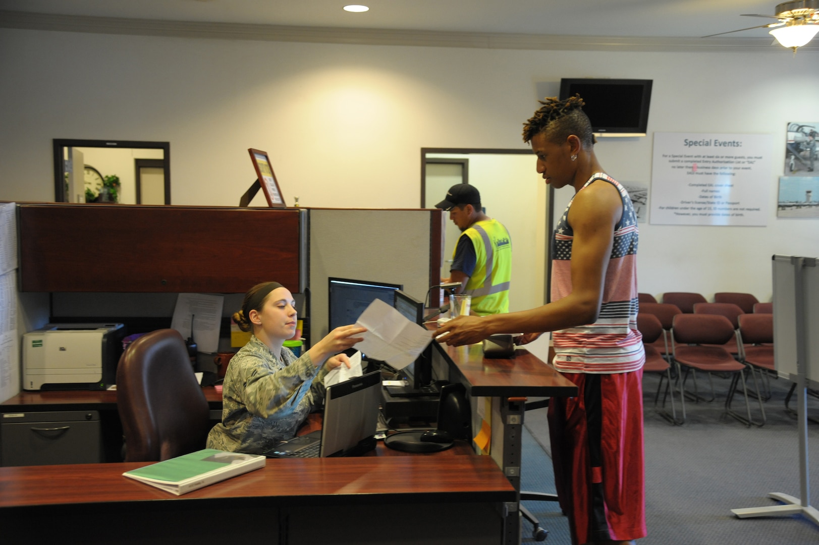 Airman 1st Class Kara Kielty, 902nd Security Forces Squadron, issues a visitor pass June 16, 2015 at the Joint Base San Antonio-Randolph Visitor Control Center.  Personnel not in possession of a Military ID, DOD civilian or contractor ID, or previously issued and active base access passes must enter JBSA-Randolph through the visitor control center. (U. S. Air Force photo by Joel Martinez)