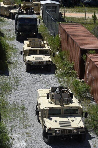 A Humvee column simulates an assault during tactical convoy operations training at Eglin Range, Fla., July 1, 2015. The 1st SOCES conducted convoy training as preparation to repair or construct equipment and facilities outside the wire during deployments. (U.S. Air Force photo by Airman Kai White/Released)