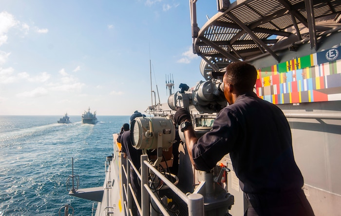 TIMOR SEA (July 11, 2015) - Quartermaster 3rd Class Ian Nteere, from Kansas City, Mo., uses binoculars on the signal bridge of the Ticonderoga-class guided-missile cruiser USS Antietam (CG 54) to observe the 
Royal Australian navy Afloat Support Force ship HMAS Sirius (O 266) (center-left) and the Royal New Zealand navy Anzac-class frigate HMNZS Te Kaha (F77) as the Antietam approaches for a fueling-at-sea in support of exercise 
Talisman Sabre (TS) 2015. TS 15 is a biennial exercise that provides an invaluable opportunity for nearly 30,000 U.S. and Australian defense forces to conduct operations in a combined, joint and interagency environment that will increase both countries' ability to plan and execute a full range of operations from combat missions to humanitarian assistance efforts. 