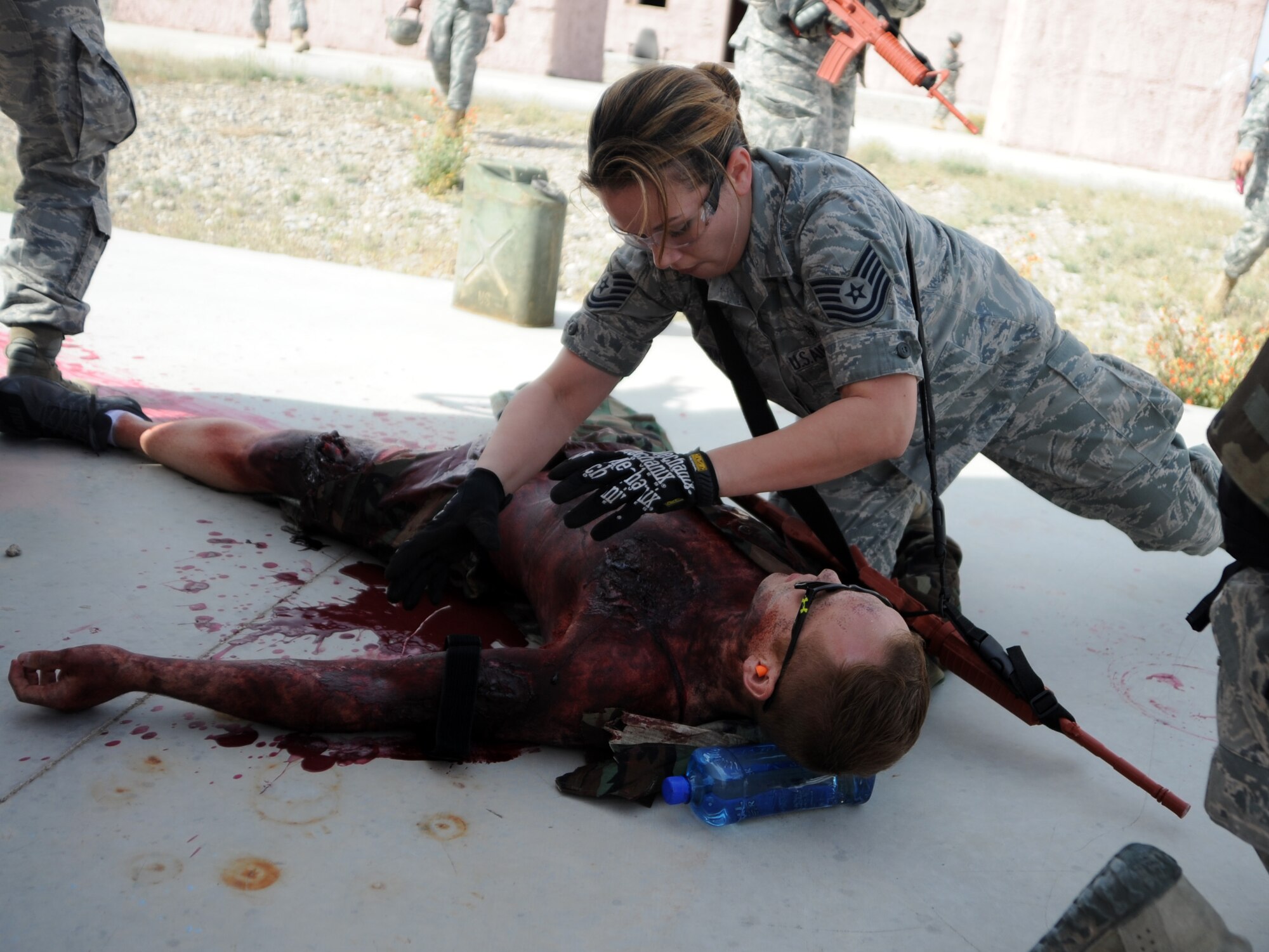 A 926th Aerospace Medicine Squadron independent duty medical technician tends to a simulated casualty during the Operation Joint Medic training exercise