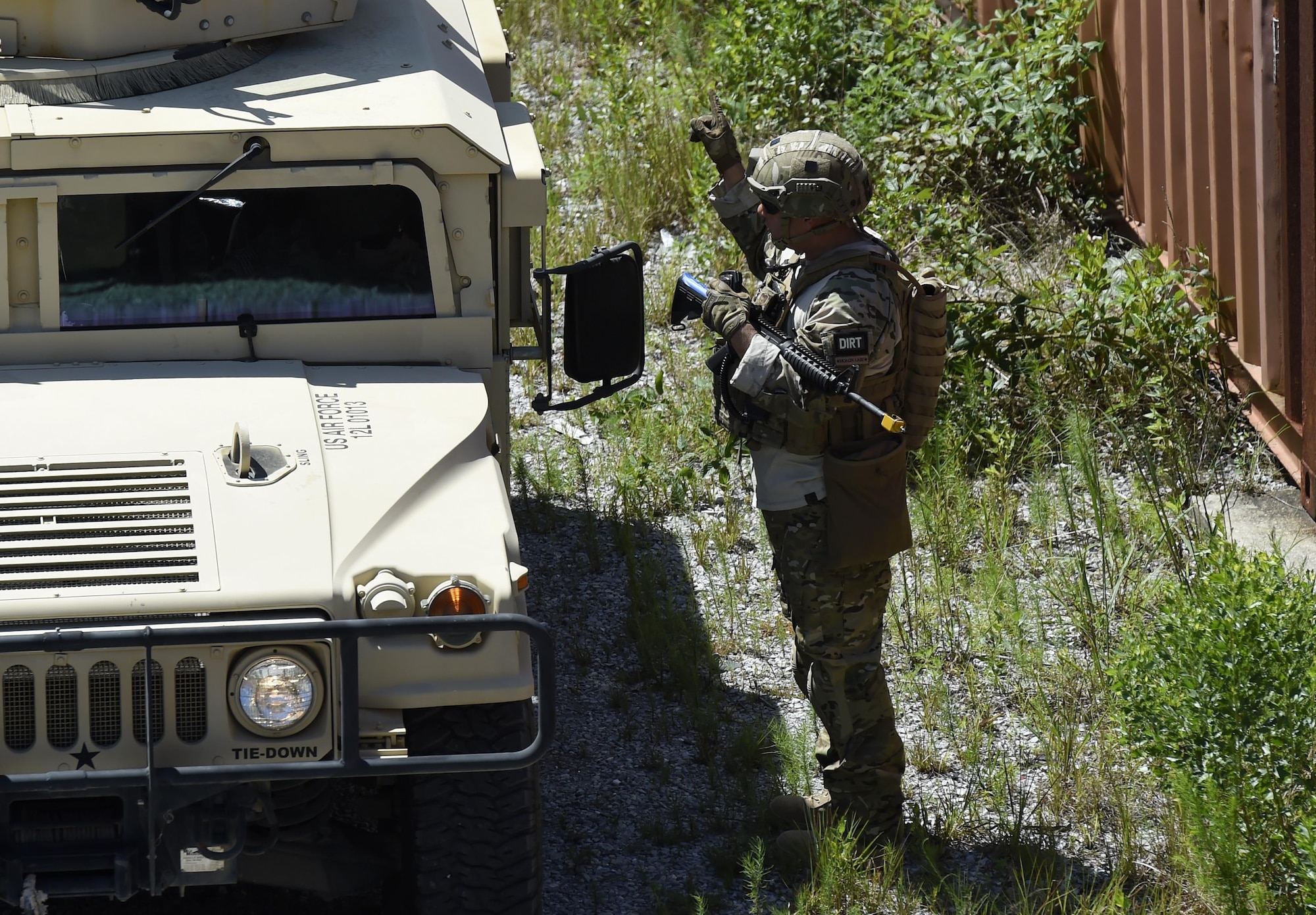 Master Sgt. Miguel Felan, 1st Special Operations Civil Engineer Squadron heavy sections chief, coordinates Humvee movement at Eglin Range, Fla., July 1, 2015. The 1st SOCES conducted convoy training as preparation to repair or construct equipment and facilities outside the wire during deployments. (U.S. Air Force photo by Airman Kai White/Released)