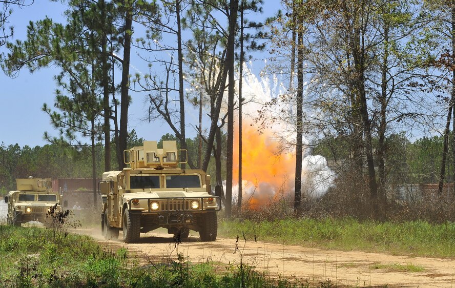 A simulated improvised explosive device detonates near a convoy during tactical convoy operations training at Eglin Range, Fla., July 1, 2015. The 1st SOCES conducted convoy training as preparation to repair or construct equipment and facilities outside the wire during deployments. (U.S. Air Force photo by Airman Kai White/Released)