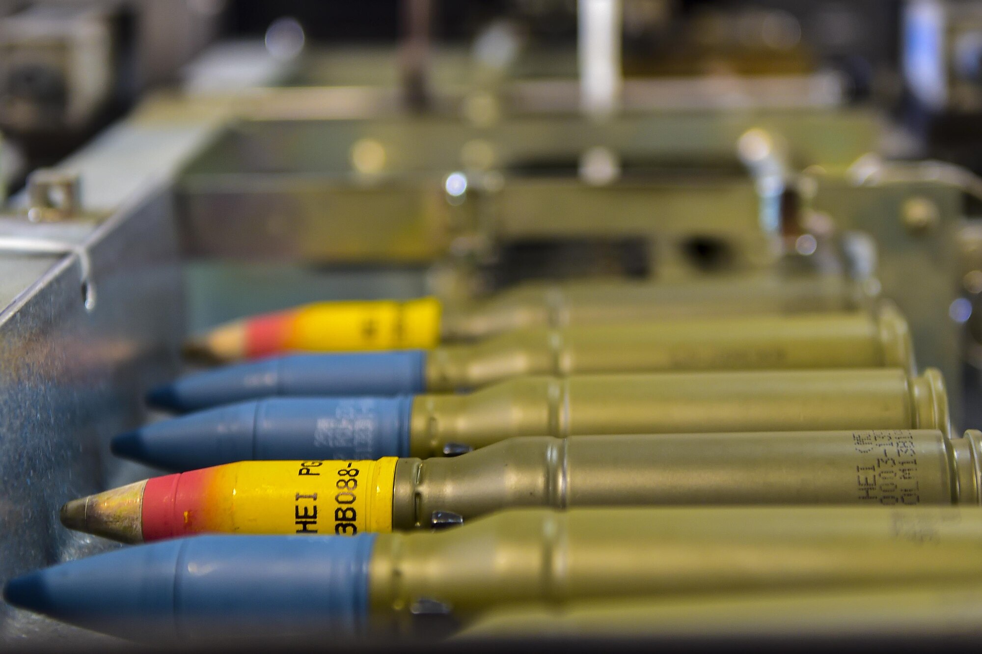 Rounds move through the 25mm processor at Hurlburt Field, Fla., June 23, 2015. The processor inserts the rounds into linked carrier tubes to be transported to the flightline. (U.S. Air Force photo/Senior Airman Jeff Parkinson)