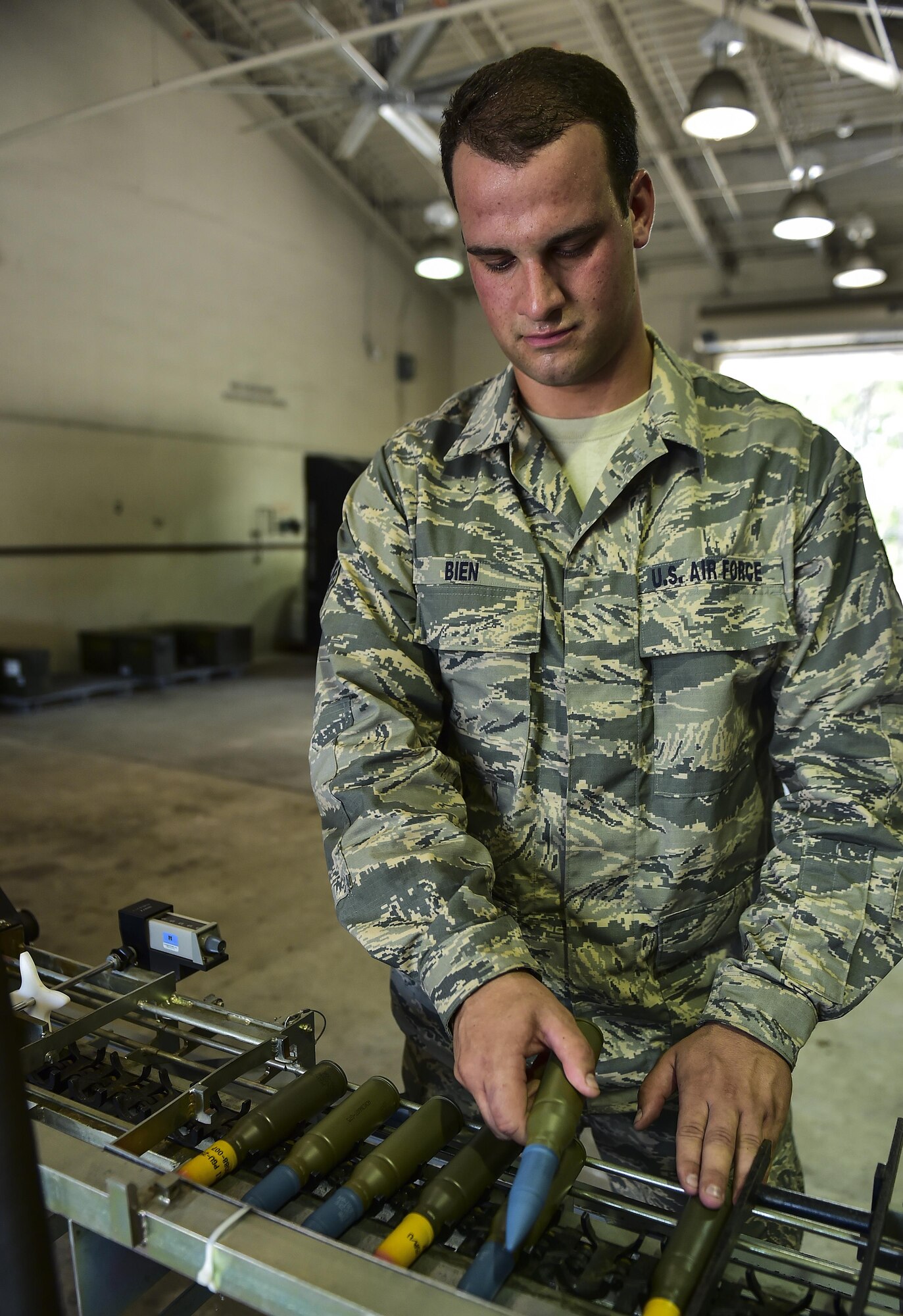 Senior Airman Alexander Bien, 1st Special Operations Equipment Maintenance Squadron conventional maintenance crew chief, loads the 25mm processor at Hurlburt Field, Fla., June 23, 2015. The 25mm processor loads the ammunition into linked tube carriers for transport to the flightline. (U.S. Air Force photo/Senior Airman Jeff Parkinson)
