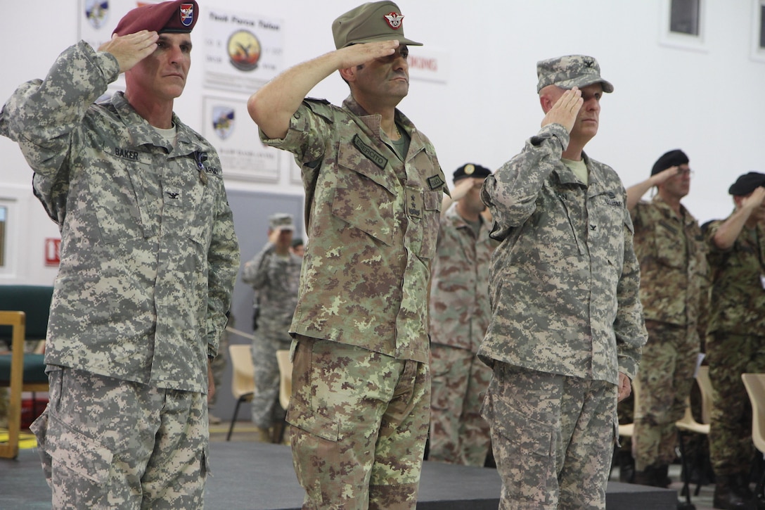 U.S. Army Col. Clint Baker, the commander of 4th Infantry Brigade Combat Team (Airborne), 25th Infantry Division (left); Italian Maj. Gen. Francesco Paolo Figliuolo, the Kosovo Force commanding general; and U.S. Army Col. Vernon Simpson, the 30th Armored Brigade Combat Team commander, salute the colors during a Multinational Battle Group-East transfer of authority ceremony July 9, 2015, at Camp Bondsteel, Kosovo. MNBG-E is a U.S.-led contingent of the NATO peace support mission in Kosovo known as KFOR, and includes forces from Armenia, Germany, Hungary, Poland, Romania, Solvenia, and Turkey. (U.S. Army photo by Sgt. Erick Yates, Multinational Battle Group-East)