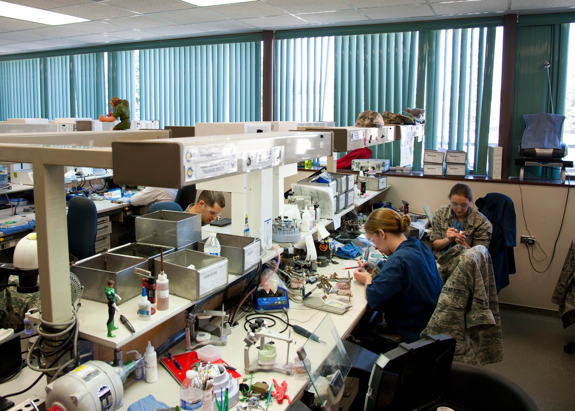 PETERSON AIR FORCE BASE, Colo. – Dental lab technicians work on numerous dental work orders from other Department of Defense bases at the Area Dental Lab, April 8, 2015. The ADL is one of three DOD labs that provide fixed dental works along with removable dental works and services DOD bases across the nation. The other two ADLs are in Ramstein AB, Germany and Kadena AB, Japan. (U.S. Air Force photo by Senior Airman Tiffany DeNault)