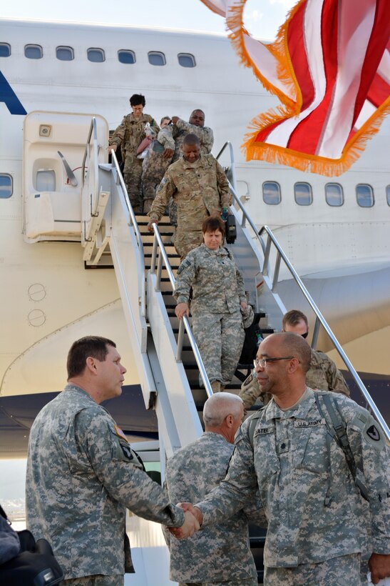 Brig. Gen. James Blakenhorn, left, deputy commander of the 335th Signal Command (Theater), greets soldiers from Detachment 34 returning home from a yearlong deployment overseas on the tarmac at Fort Bliss, Texas. (Photo by Sgt. 1st Class Anthony Florence)