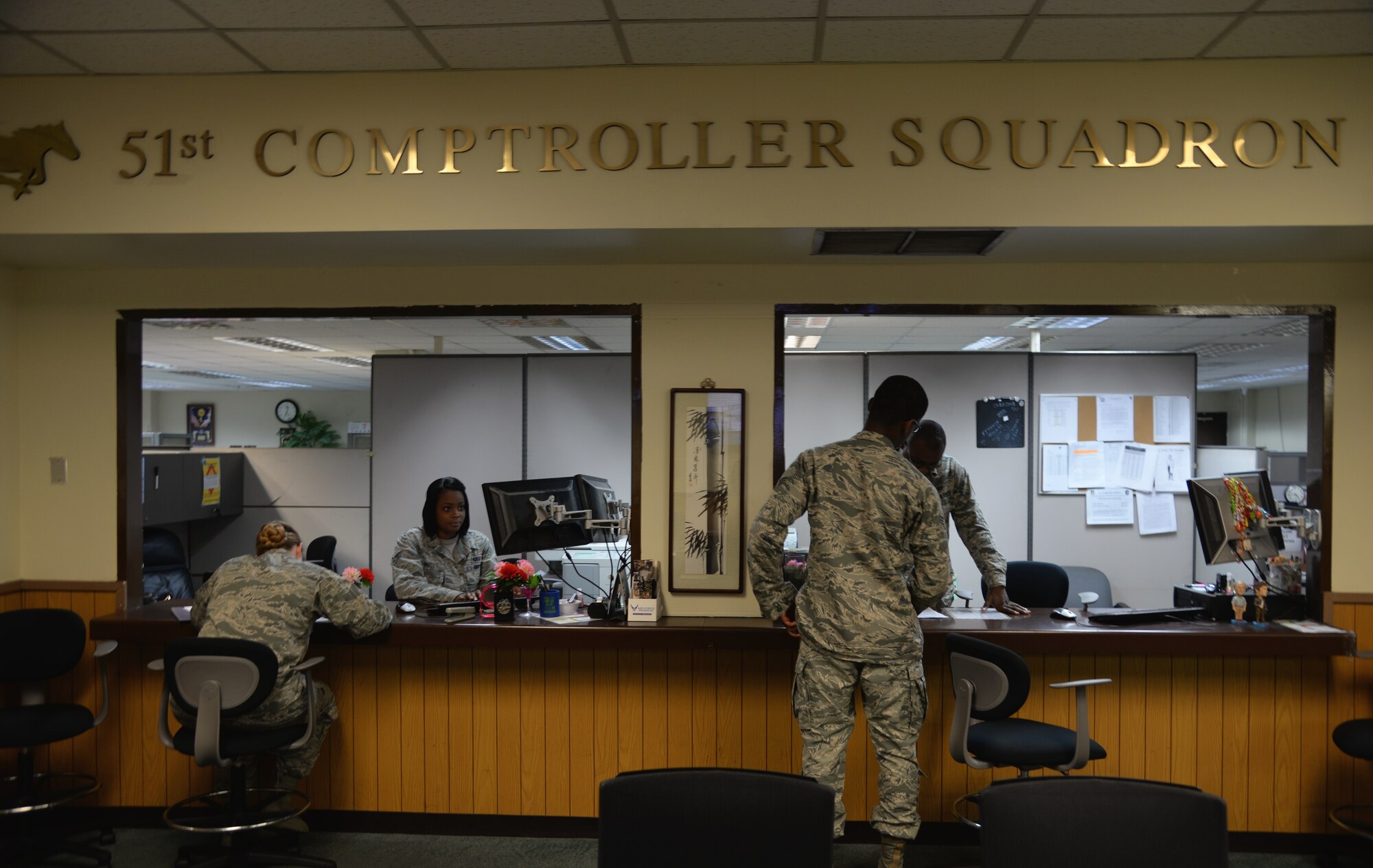 Airmen assigned to the 51st Comptroller Squadron assist customers with financial related questions July 7, 2015, at Osan Air Base, Republic of Korea. The comptroller team manages travel vouchers and disbursements, allotments, pay changes, and other financial needs for about 5,500 personnel assigned to the 51st FW, Headquarters 7th Air Force, and other Air Force, Army, Navy and Marine Corps units. (U.S. Air Force photo by Staff Sgt. Benjamin Sutton)