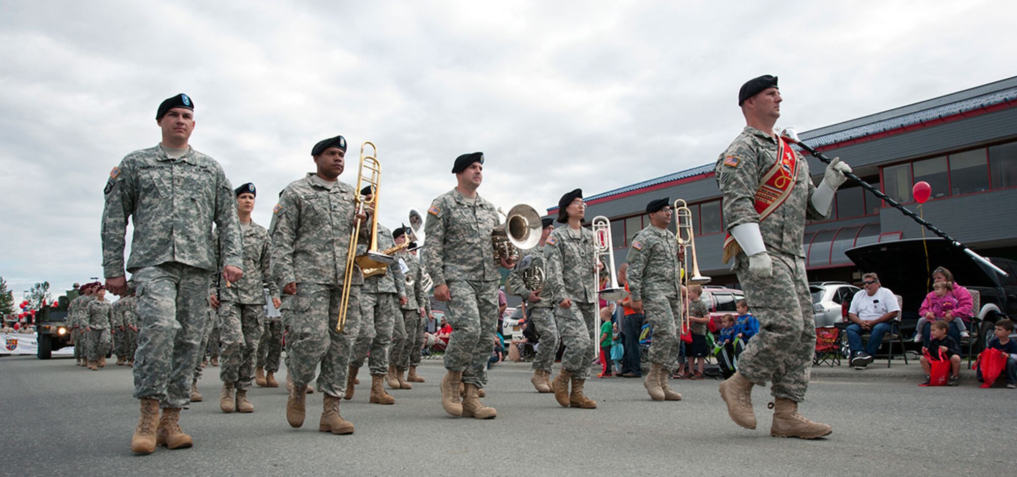 Soldiers from Fort Wainwright’s 9th Army Band participate in the annual Bear Paw Parade in Eagle River, Alaska, July 11, 2014. The parade is part of a five-day festival hosted every year by the Eagle River Chamber of Commerce. This year is the 30th annual Bear Paw Festival. (U.S. Air Force photo/Senior Airman Tammie Ramsouer)