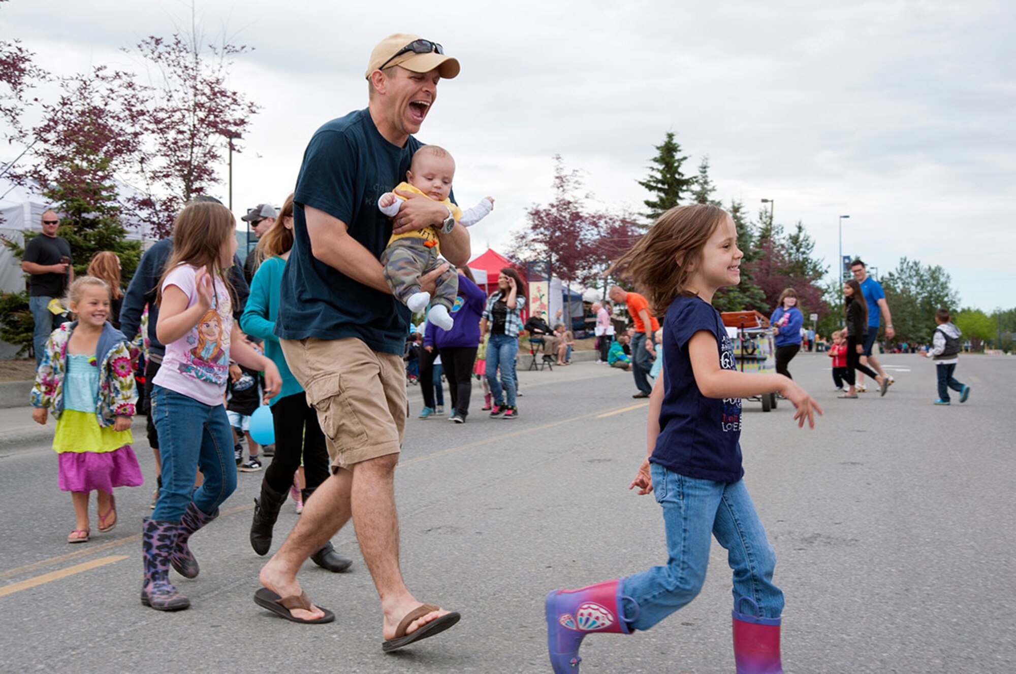 The local community, service members and their families participate in family games before the start of the Bear Paw Parade in Eagle River, Alaska, July 11, 2014. During Bear Paw’s five-day festival, community members can participate in many events such as a 5K run, carnival and parade. (U.S. Air Force photo/Senior Airman Tammie Ramsouer)