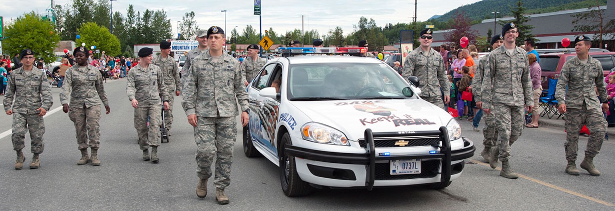 Airmen from Joint Base Elmendorf-Richardson, Alaska participate in the annual Bear Paw Parade in Eagle River, Alaska, July 11, 2015. The Joint Base Against Drunk Driving and Drug Abuse Resistance Education vehicles, a Soldier marching unit from Joint Base Elmendorf-Richardson, and the 9th Army Band from Fort Wainwright, Alaska participated in this year’s Bear Paw Parade. (U.S. Air Force photo/Senior Airman Tammie Ramsouer)