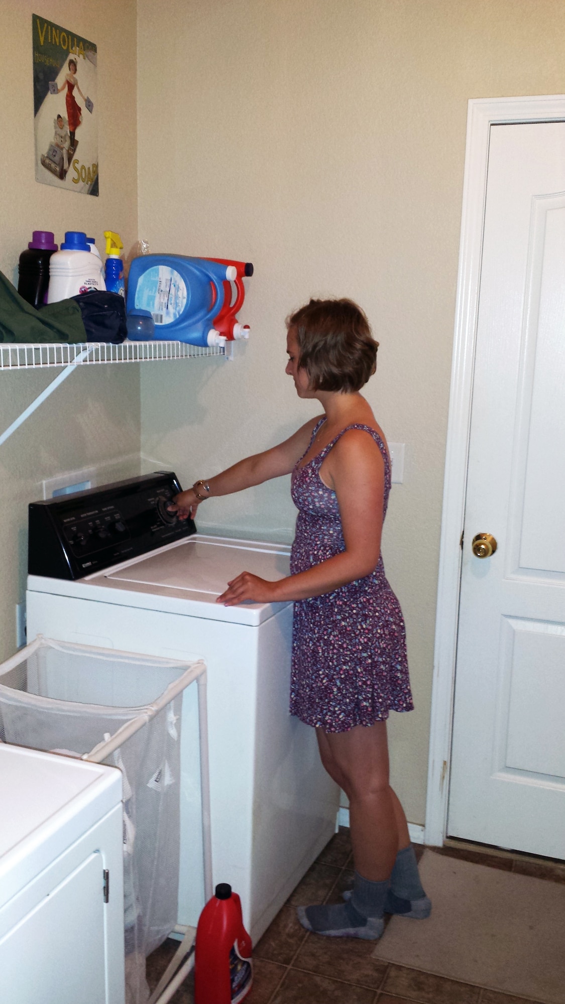 Cadet 3rd Class Jenna Gustafson, does laundry at her sponsor's house July 10, 2015. She is sponsored by Harry and retired master sergeant Tracey Lundy. Sponsor families give cadets a place to do laundry, eat home cooked meals and study in a relaxed environment. (U.S. Air Force photo by Harry Lundy).