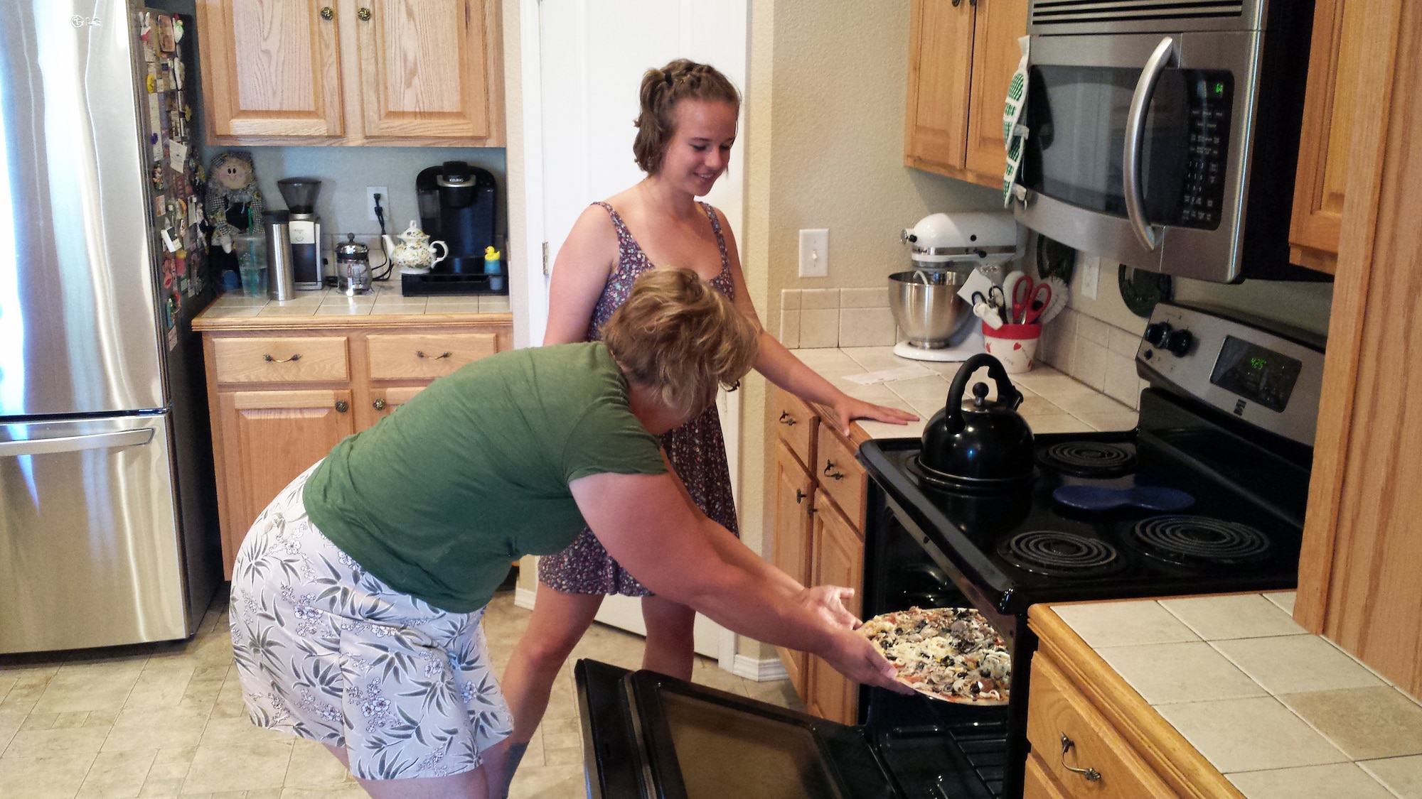 Cadet sponsor and retired master sergeant, Tracey Lundy, cooks dinner for Cadet 3rd Class Jenna Gustafson July 10, 2015. Sponsor families give cadets the opportunity to enjoy home cooked meals, as well as a place to unwind. (U.S. Air Force photo by Harry Lundy)