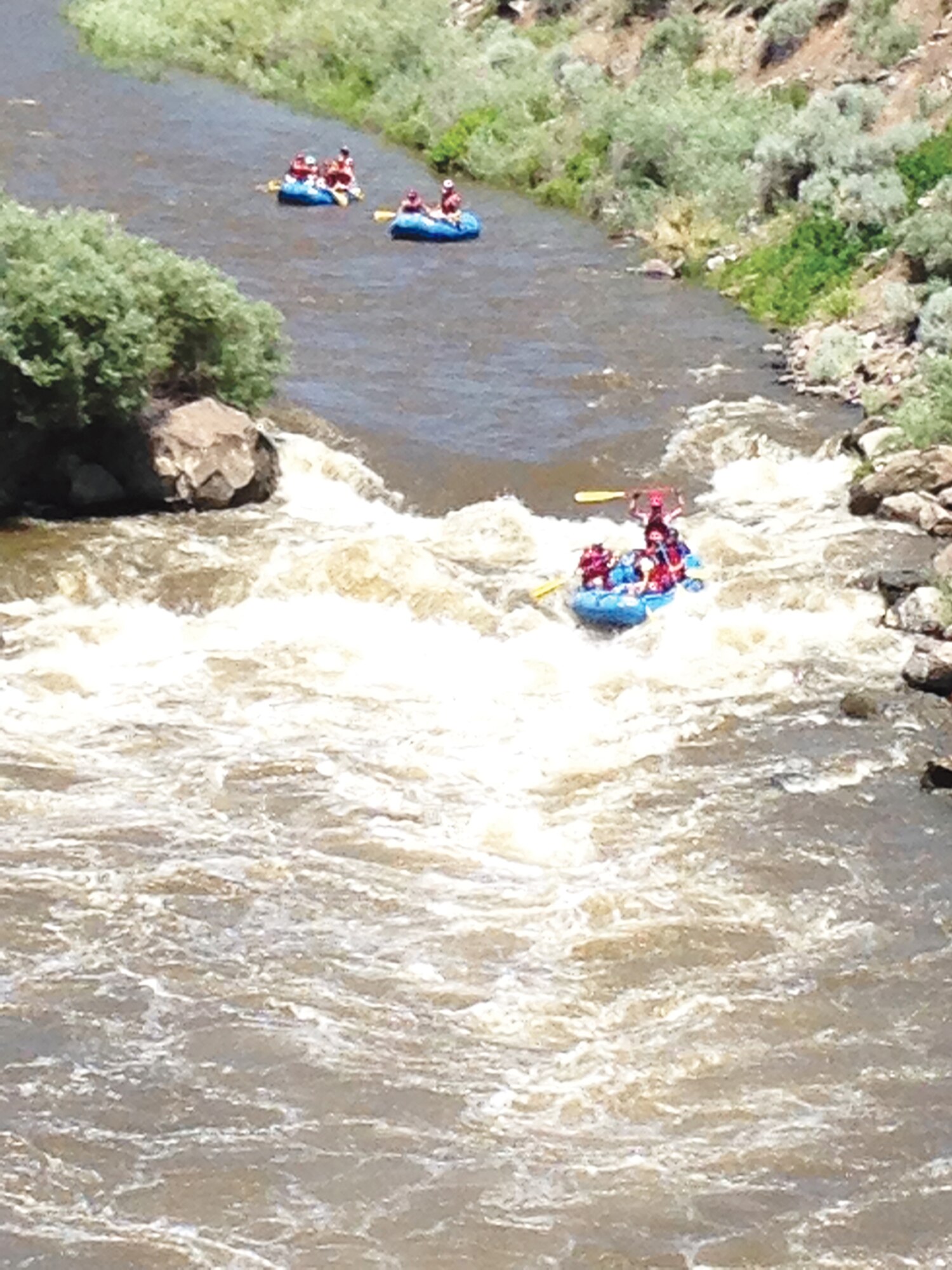 A group of volunteer rafting guides take a group of Outdoor Recreation clients on a trip down the Race Course on the Rio Grande, just outside of Pilar, N.M. in June. (Photo by Misty Kuhl)