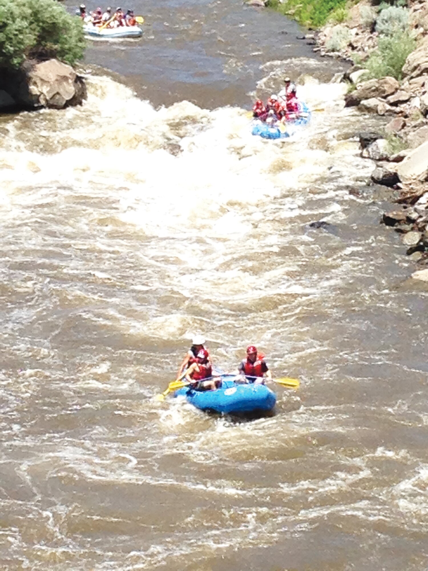 A group of volunteer rafting guides take a group of Outdoor Recreation clients on a trip down the Race Course on the Rio Grande, just outside of Pilar, N.M. in June. (Photo by Misty Kuhl)