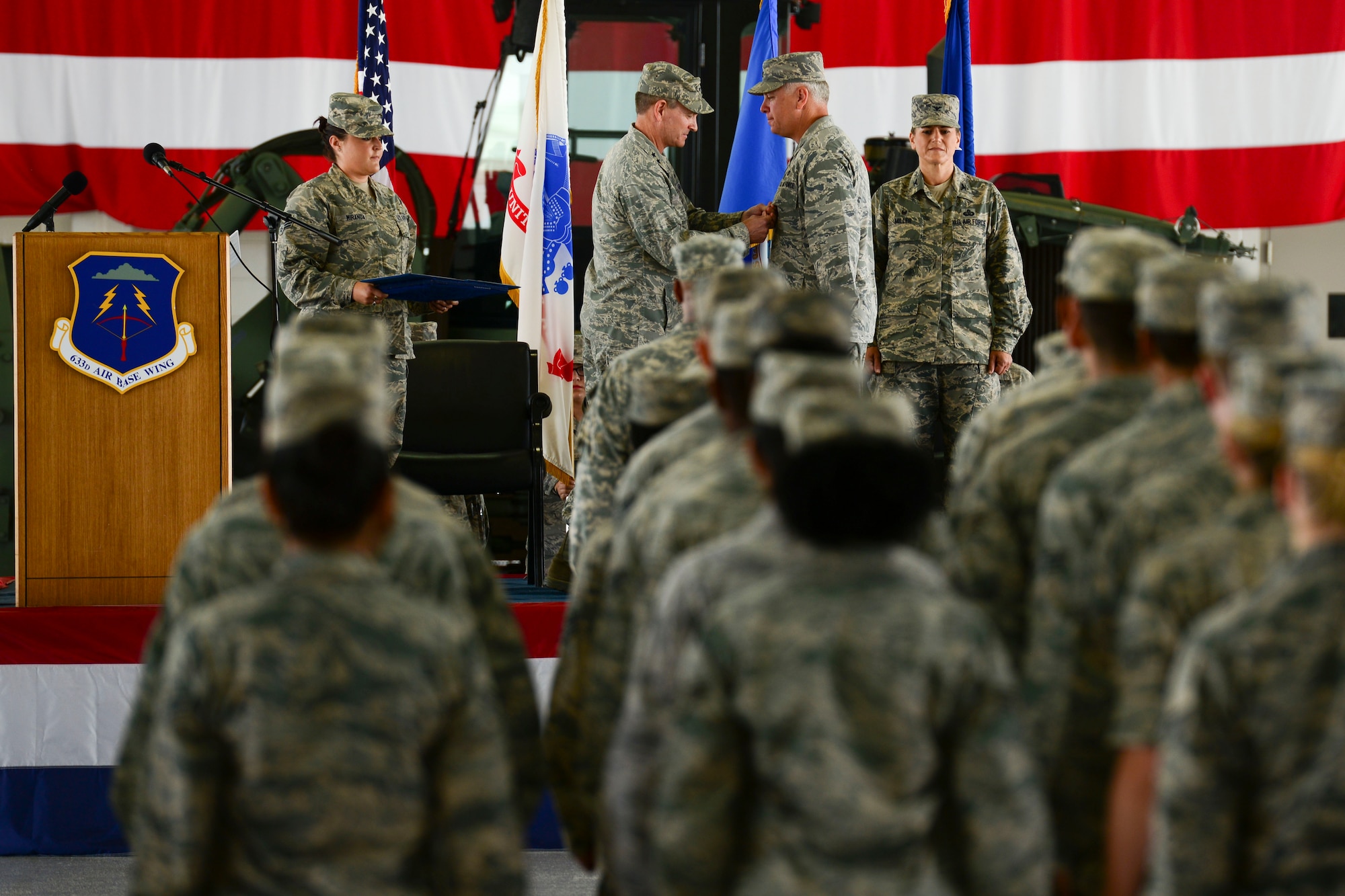 U.S. Air Force Maj. Gen. H.D. Polumbo, 9th Air Force commander, presents the Legion of Merit to Col. John Allen, 633rd Air Base Wing commander, during the wing change of command ceremony at Langley Air Force Base, Virginia, July 13, 2015. Allen has commanded the 633rd ABW since April 2013. (U.S. Air Force photo by Staff Sgt. Ciara Gosier/Released)