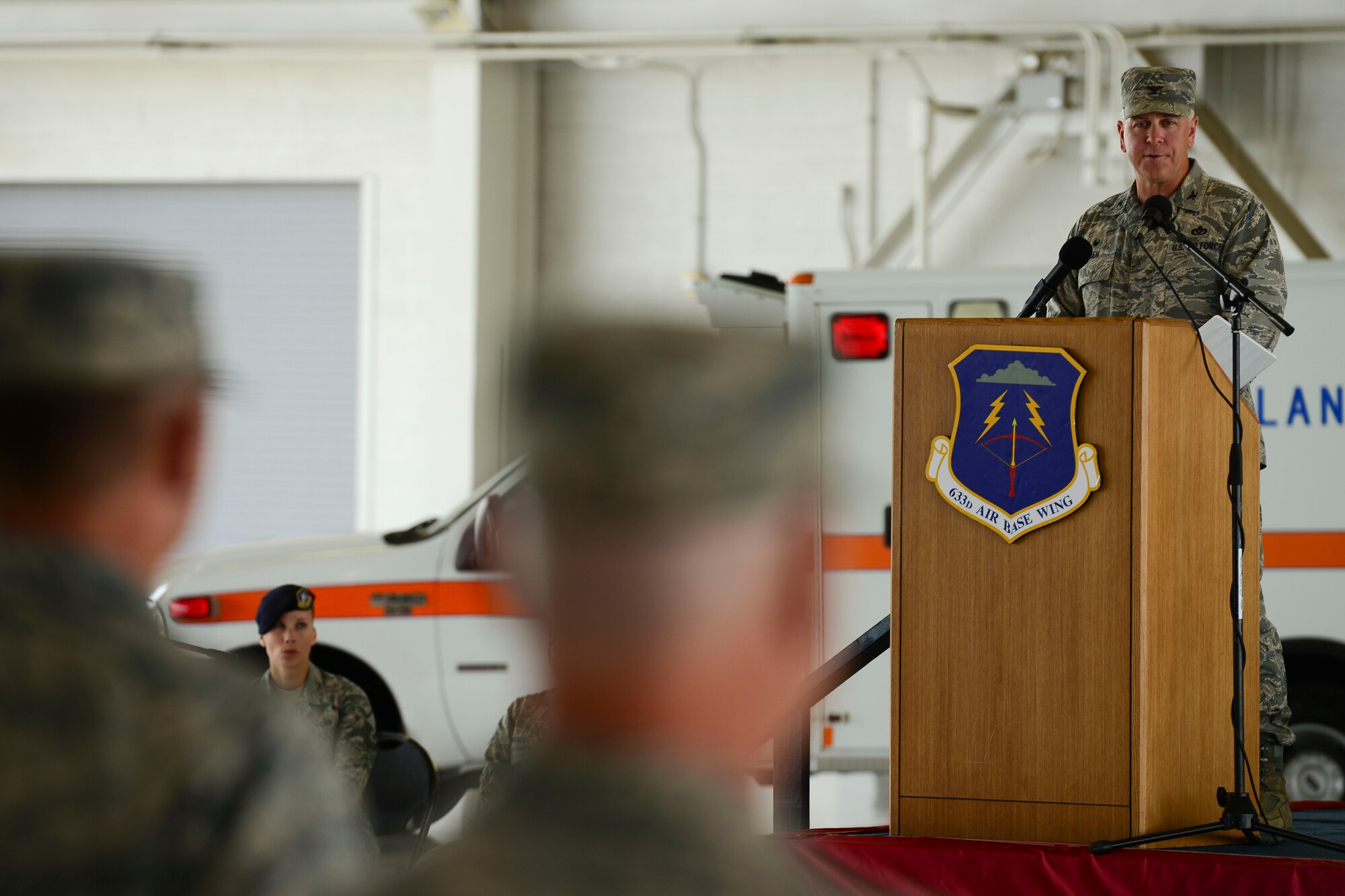 U.S. Air Force Col. John Allen, 633rd Air Base Wing commander, addresses the crowd during the wing change of command ceremony at Langley Air Force Base, Virginia, July 13, 2015. As the commander, Allen was responsible for more than 9,000 military and civilian personnel including Headquarters Air Combat Command and three operational groups. (U.S. Air Force photo by Staff Sgt. Ciara Gosier/Released)