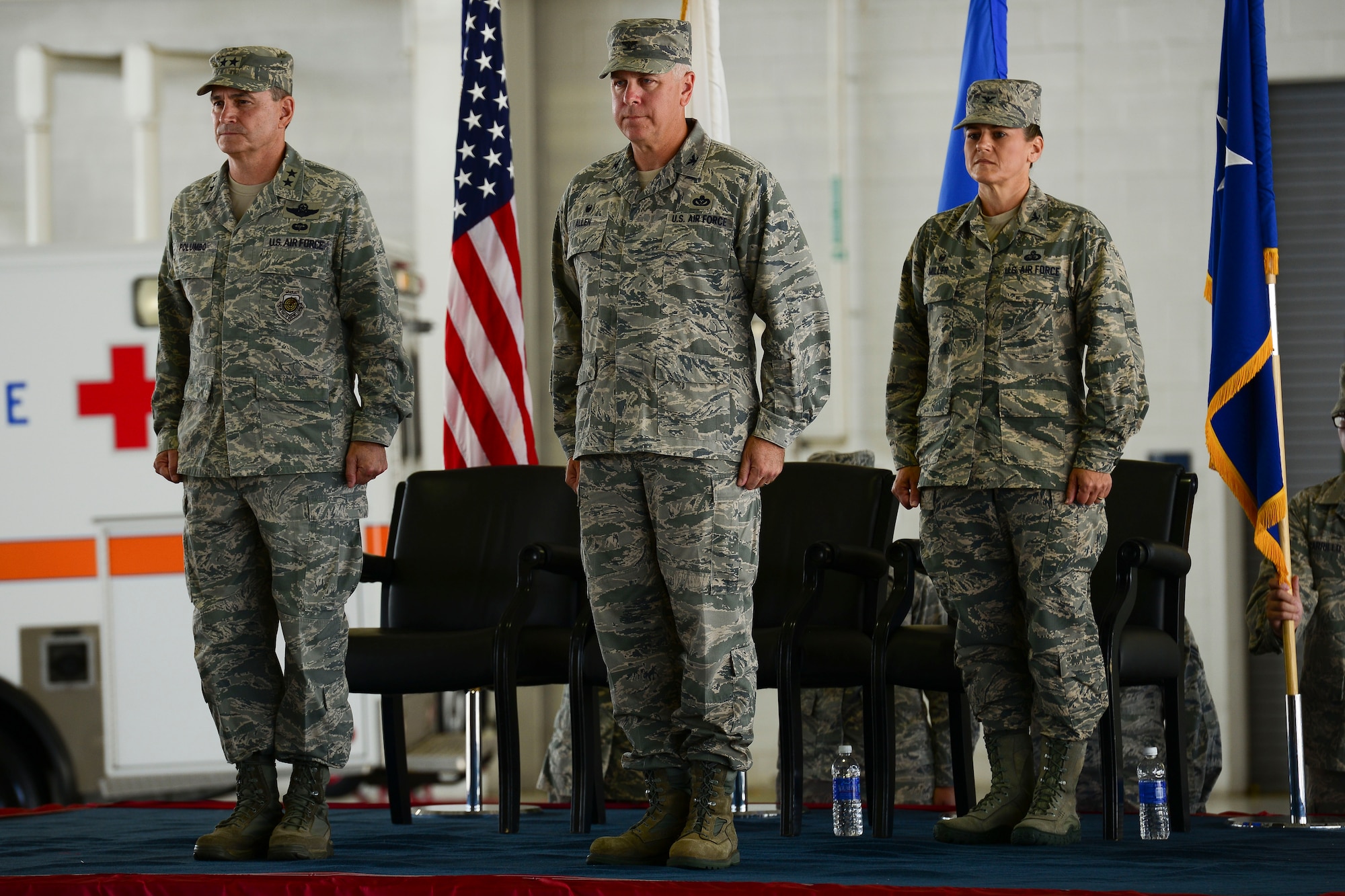 From left, U.S. Air Force Maj. Gen. H.D. Polumbo, 9th Air Force commander, Col. John Allen, 633rd Air Base Wing outgoing commander and Col. Caroline Miller, 633rd ABW incoming commander, stand at attention during the wing change of command ceremony at Langley Air Force Base, Virginia, July 13, 2015. After serving as the commander for the last two years, Allen will go on to serve as the Air Force liaison to the U.S. Senate. (U.S. Air Force photo by Staff Sgt. Ciara Gosier/Released)