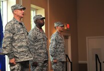 (From left to right) Col. Joe Slavick, 4th Mission Support Group commander, Maj. Gideon Hall, 4th incoming Communications Squadron commander, and Maj. Nelson Avilesfigueroa, outgoing 4th CS commander, lead the singing of the Air Force song at the conclusion of the squadron’s change of command ceremony, July 10, 2015, at Seymour Johnson Air Force Base, North Carolina. The singing of the Air Force song and the passing of the guidon are two of several traditions observed during change of command ceremonies. (U.S. Air Force photo/Senior Airman Ashley J. Thum)