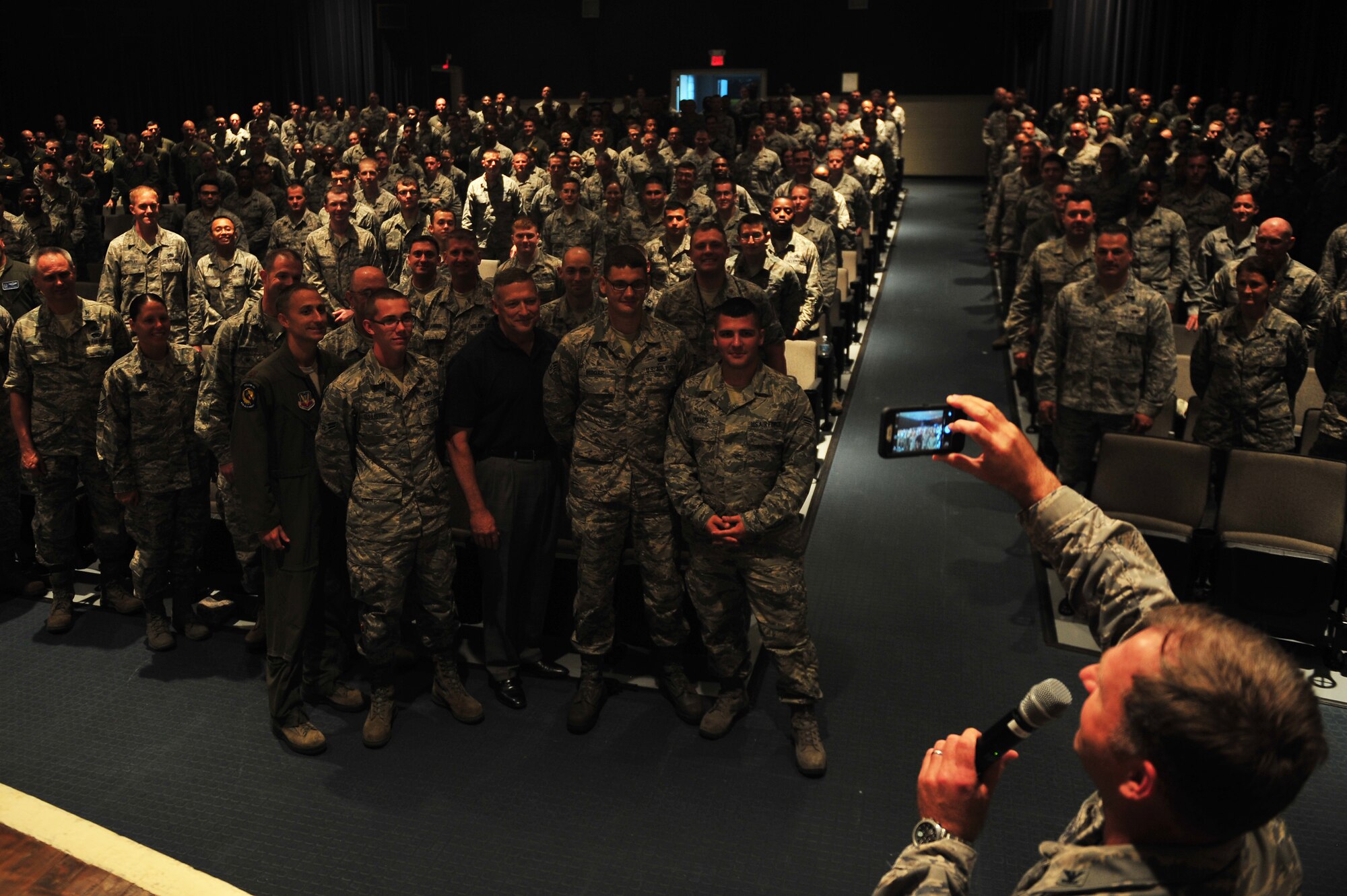 Col. Mark Slocum, 4th Fighter Wing commander, takes a photo of retired Gen. Gary North with 4th Fighter Wing Airmen after a Leadership Lecture Series event, July 9, 2015, at Seymour Johnson Air Force Base, North Carolina. North retired from the Air Force as a command pilot with more than 4,700 flying hours. (U.S. Air Force photo/Senior Airman John Nieves Camacho)