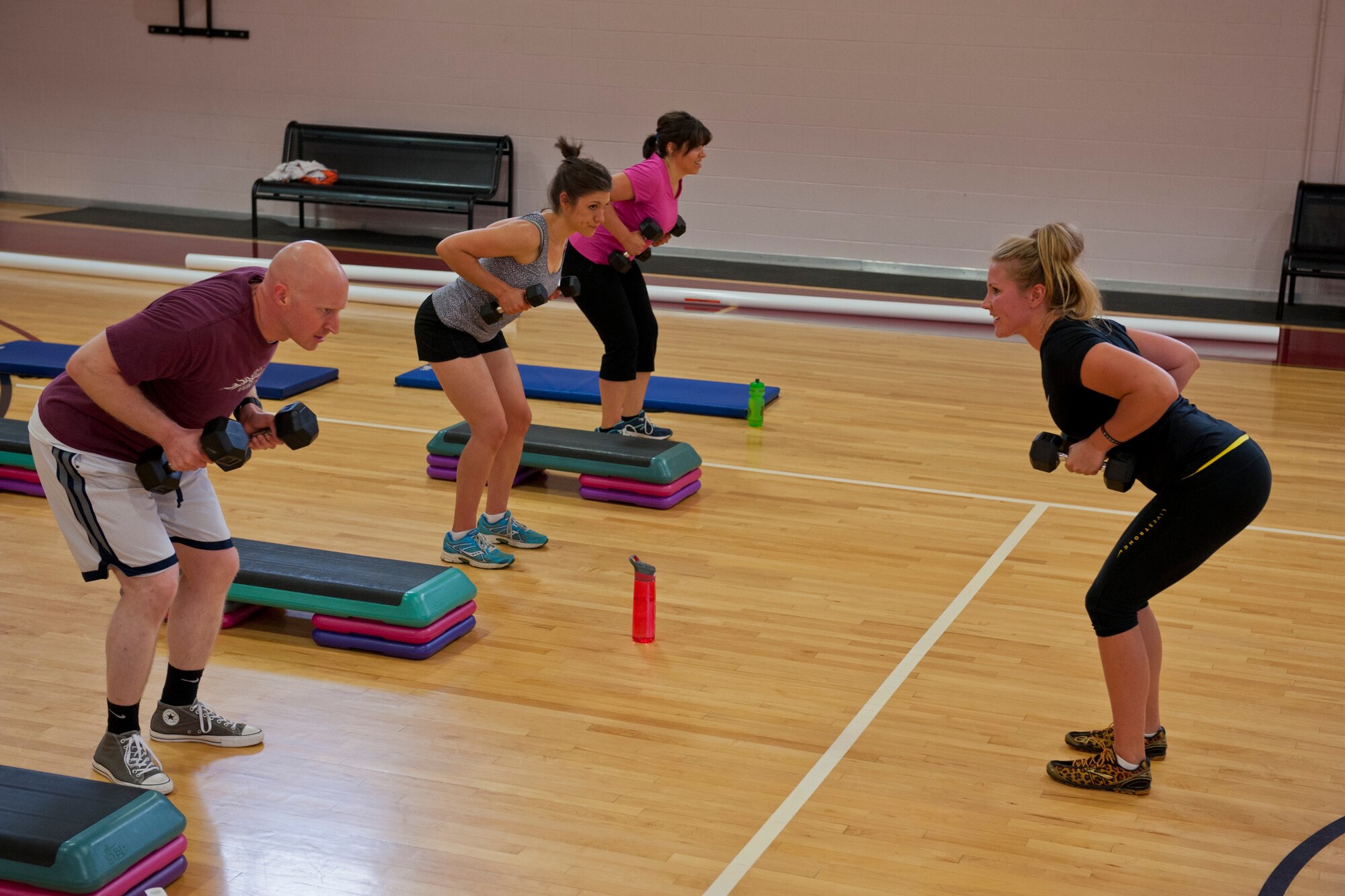 PETERSON AIR FORCE BASE, Colo. – Sarah Morris, fitness class instructor, leads a new class offered at the Peterson Air Force Base Fitness Center, July 8, 2015. The Compound is one of three new fitness classes offered at the gym, focusing on building lean muscle by incorporating cardio moves between every interval and finishes with abdominal exercises. The class is offered from 12:05–1 p.m. every Wednesday. (U.S. Air Force photo by Airman 1st Class Rose Gudex)