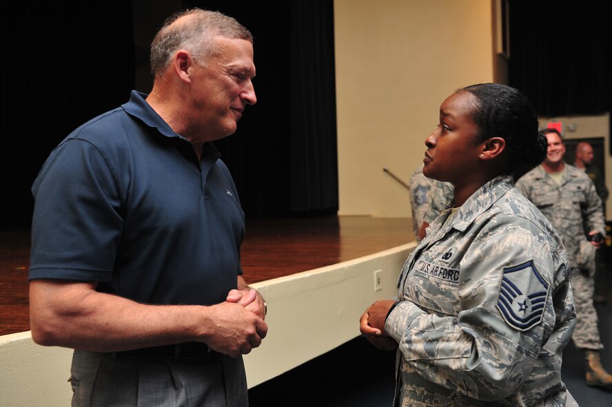 Retired Gen. Gary North speaks with Master. Sgt. Nikkia Fain, 4th Logistics Readiness Squadron aircraft parts store section chief, after a Leadership Lecture Series event, July 9, 2015, at Seymour Johnson Air Force Base, North Carolina. After sharing his military and professional experiences with Airmen across the base, North made himself available for individual questions. (U.S. Air Force photo/Senior Airman John Nieves Camacho)