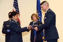 Col. Beena Maharaj, the 403rd Mission Support Group commander assists Maj. Quinton Sasnett, the outgoing 403rd Civil Engineering Squadron commander with a casing the colors event during the 403rd CES inactivation ceremony at Keesler Air Force Base July 12.