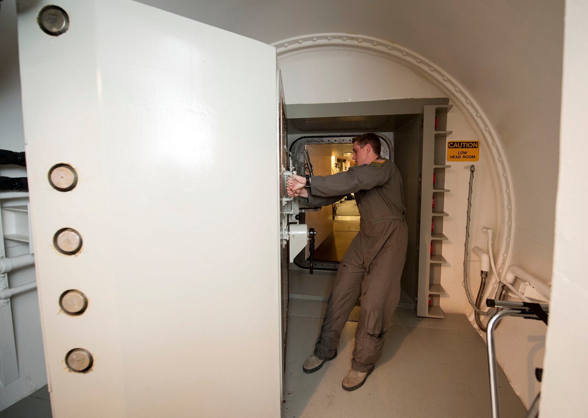 1st Lt. Daniel Morris, 740th Missile Squadron deputy combat crew commander, closes the door to the launch control center at the Bravo 01 Missile Alert Facility, July 1, 2015. The 740th MS maintains the missile force around-the-clock and controls 50 launch facilities and five missile alert facilities within their area of the missile complex. (U.S. Air Force photo/Senior Airman Stephanie Morris)