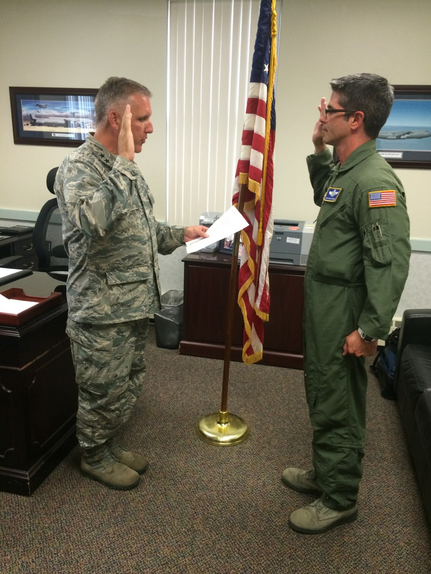 Maj. Gen. John C. Flournoy Jr., 4th Air Force commander, administers the oath of enlistment to Master Sgt. Sean Barnum, 709th Airlift Squadron,  July 12, 2015, at Dover Air Force Base, Del.  Barnum, an 18-year C-5 A/B/M loadmaster, re-enlisted for 6 years. Also during the general's three-day stay, he met with Airmen through various forums, toured facilities and participated in a fitness challenge event. (U.S. Air Force photo/Chief Master Sgt. Dean Reed)