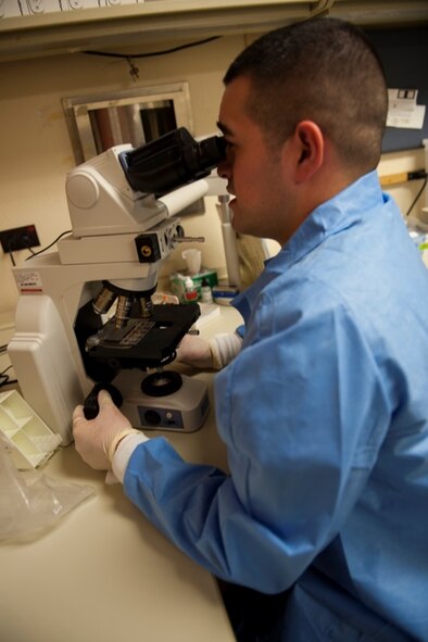 Senior Airman Luis Poblano, 5th Medical Support Squadron laboratory technician, examines a sample at Minot Air Force Base, N.D., July 8, 2015. Examinations like these are important to the Minot mission because they make sure Airmen are fit to fight. (U.S. Air Force photo/Airman 1st Class Christian Sullivan)