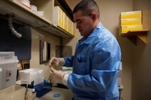 Senior Airman Luis Poblano, 5th Medical Support Squadron laboratory technician, prepares a sample for testing at Minot Air Force Base, N.D., July 8, 2015. Urinalysis is a key part in maintaining Air Force standards of being fit to fight and Airmen readiness. (U.S. Air Force photo/Airman 1st Class Christian Sullivan)