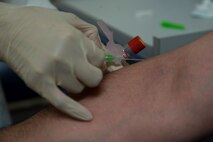 Senior Airman Luis Poblano, 5th Medical Support Squadron laboratory technician, prepares to have his blood drawn at Minot Air Force Base, N.D., July 8, 2015. Blood work is one of many tasks handled by personnel that work in the lab. (U.S. Air Force photo/Airman 1st Class Christian Sullivan)