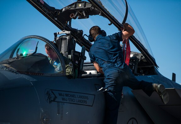 An Airman from the 389th Aircraft Maintenance Squadron places a canopy strut to hold the canopy open at Nellis Air Force Base, Nev., July 7, 2015. Red Flag 15-3 is a realistic combat training exercise involving the air forces of the United States and its allies. The exercise is conducted on the 15,000-square-mile Nevada Test and Training Range, located north of Las Vegas. (U.S. Air Force photo by Senior Airman Brittany A. Chase)