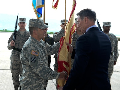 Col. Dan Barzyk, Army Support Activity incoming commander, receives the guidon from Mr. Thomas Schoenbeck, U.S. Army Installation Management Command regional director, during the Army Support Activity change of command July 9, 2015, at Soto Cano Air Base, Honduras. The change of command signified the passing of responsibilities from the previous commander, Col. Rollin Miller, to Barzyk. (U.S. Air Force photo by Staff Sgt. Jessica Condit)