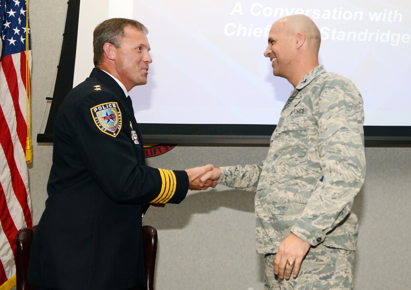 U.S. Air Force Col. Michael Bob Starr, 7th Bomb Wing commander, presents Stan Standridge, Abilene Chief of Police, with a commander’s coin during Dyess’ monthly Leadership and Innovation Forum June 16, 2015, at Dyess Air Force Base, Texas. Standridge was the guest speaker during the forum, which is hosted to shed light on topics associated with leadership and innovation and relate it to Airmen. (U.S. Air Force photo by Senior Airman Kedesha Pennant/Released)