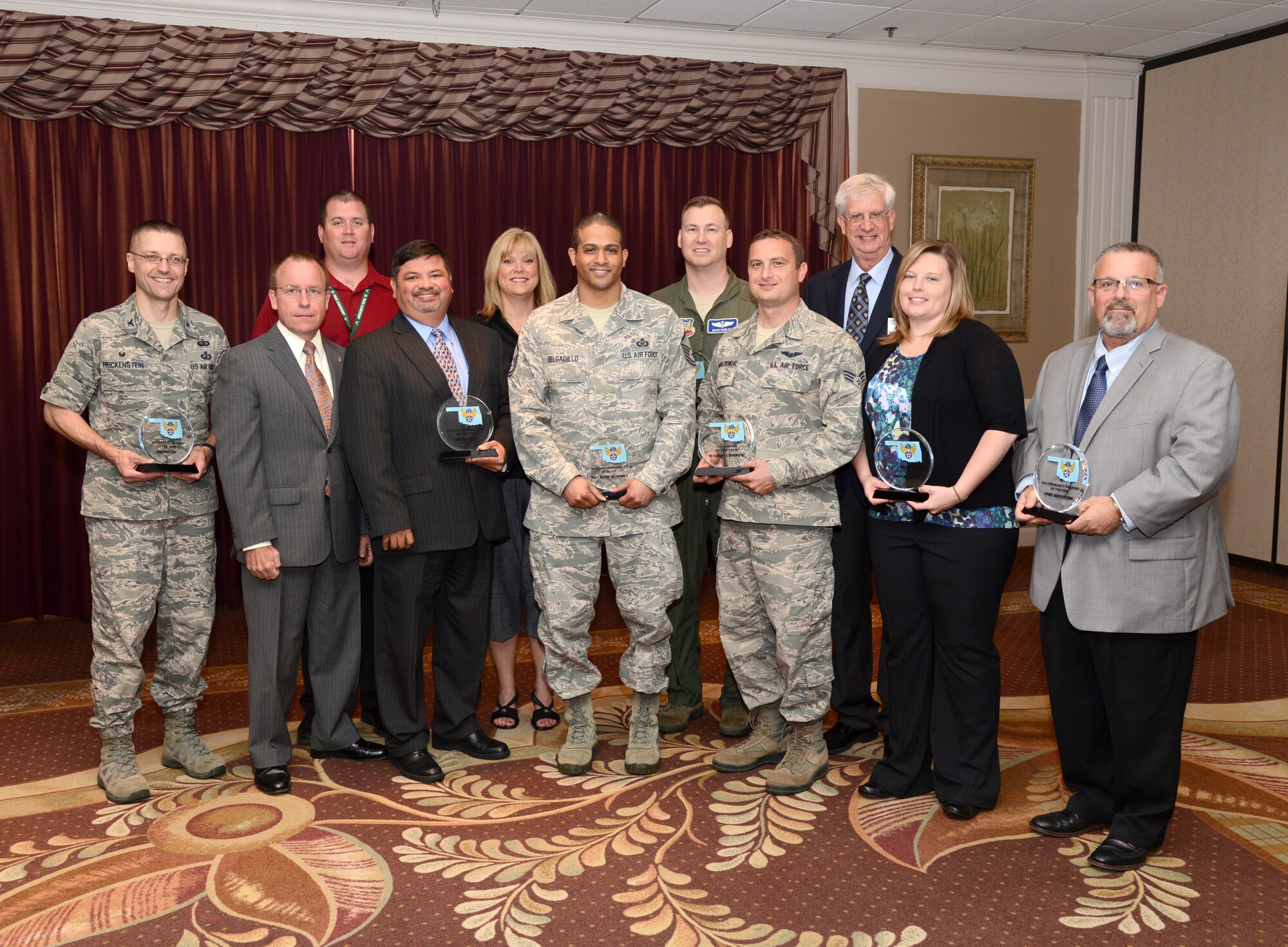 The Air Force Association Gerrity Chapter 215 held its annual awards breakfast June 23 at the Tinker Club. Pictured are, front row from left, Col. Scott Frickenstein, former commander of the OU AFROTC Detachment, who accepted the AFROTC Cadet of the Year Award for Jeremiah Cox; Jeffrey Allen, Air Force Sustainment Center executive director and guest speaker of the event; James Hunt, 76th Propulsion Maintenance Squadron, the Civilian Manager of the Year; Joe Lopez, director of the 550th Commodities Maintenance Squadron, which won Best Military Unit of the Year; Vicki Hoppes, from the 72nd Logistics Readiness Squadron and recipient of the Contractor Non-Exempt award; Master Sgt. Alexis Delgadillo, 552nd Operations Support Squadron, the Senior Noncommissioned Officer of the Year; Capt. Brian Hamilton, 552nd OSS, the Company Grade Officer of the Year; Senior Airman Alexander Banachowski, 552nd OSS, the Airman of the Year; Mark Tarpley, AFA Gerrity Chapter 215 president; Laura Duck, 76th Propulsion Maintenance Group, the Civilian Technician of the Year; and Robert Recchio, representing Spirit AeroSystems, Inc. which won the Gerrity Community Partner of the Year. Not pictured is Tech. Sgt. Heather Bennett, 507th Security Forces Squadron, the Nonnommissioned Officer of the Year. (Air Force photo by Kelly White/Released)