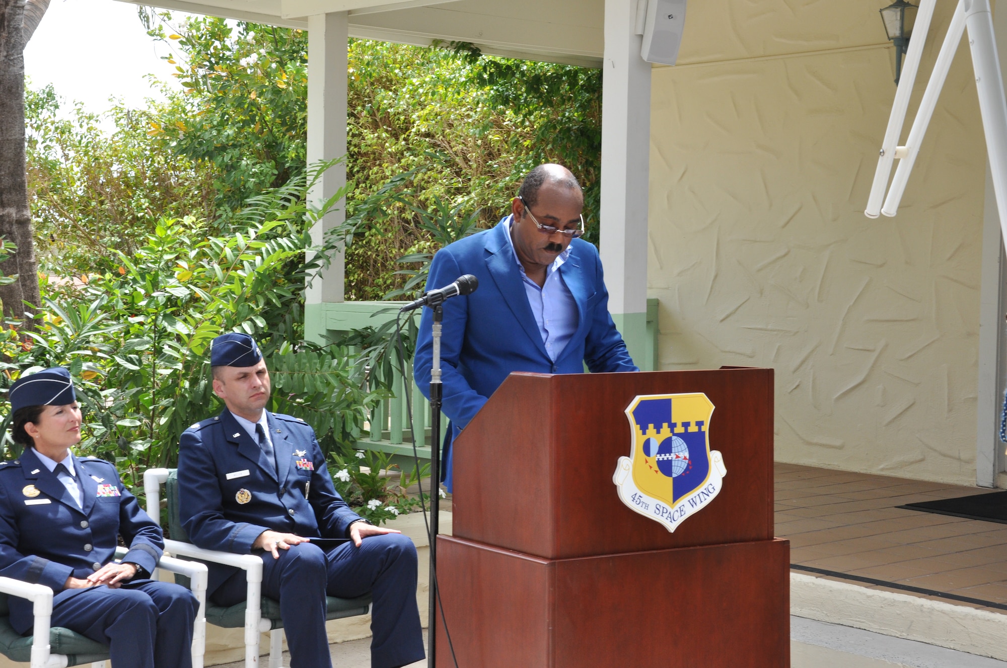 The Honorable Gaston Browne, Prime Minister of Antigua and Barbuda, provides remarks during the Antigua Air Station inactivation ceremony while Brig. Gen. Nina Armagno, 45th Space Wing commander, left, and Lt. Col. Steven Melvin, Detachment 1, 45th Operations Group commander, center, listen July 7, 2015, at Antigua. Originally established as a revision of a land-lease agreement with Great Britain, the mission of the air station’s Det 1 was to support the space-lift mission of the Eastern Range by providing high data rate telemetry. (U.S. Air Force photo by 1st Lt. Alicia Wallace)(Released)