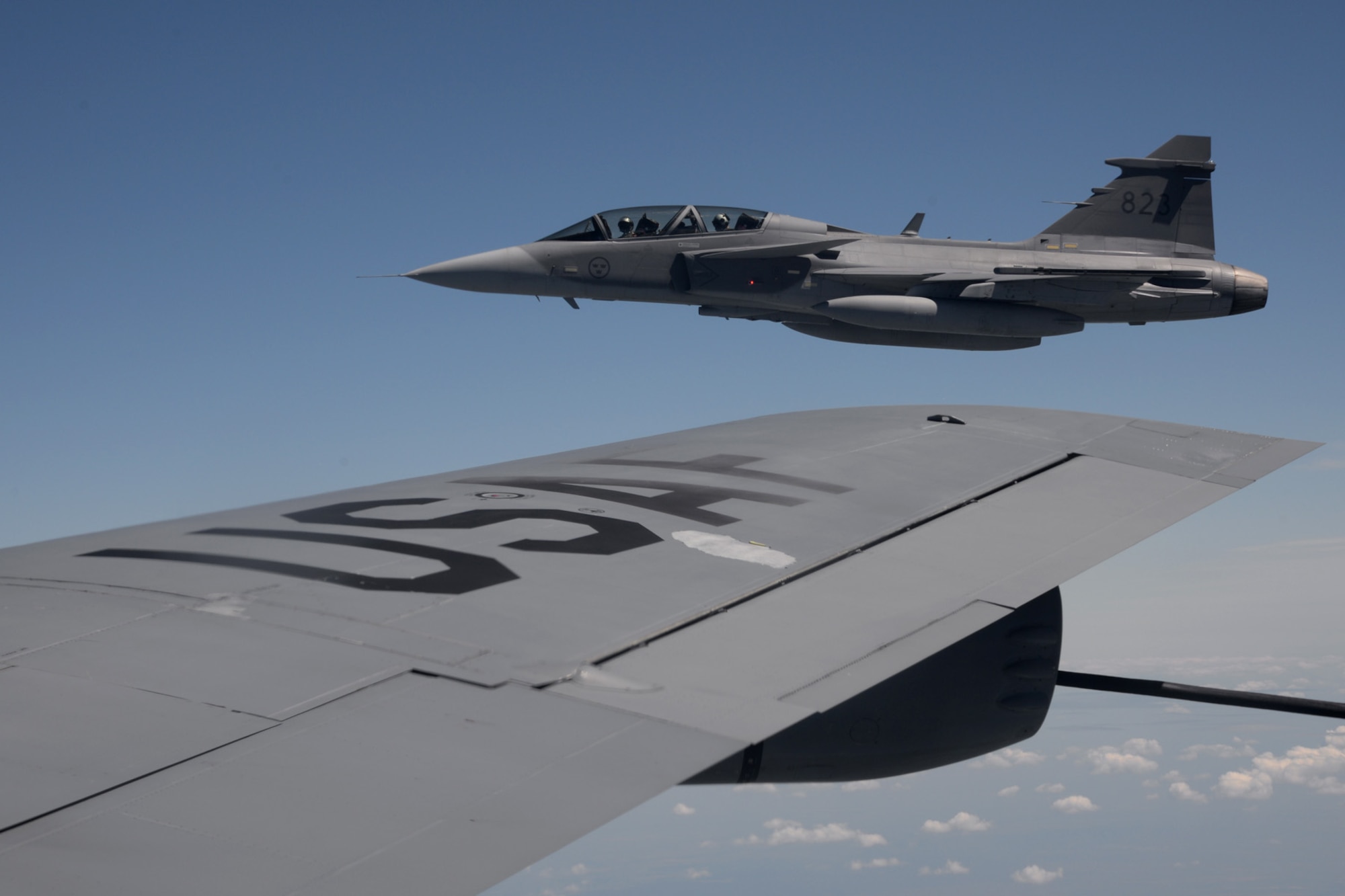 A Swedish air force JAS-39 Gripen flies next to a U.S. Air Force KC-135 Stratotanker June 26, 2015, during air refueling familiarization training over Hungary. Hungarian, U.S. and Swedish air force personnel met for a two-week familiarization period enabling the Hungarian JAS-39 Gripen pilots to successfully perform air refueling for the first time. (U.S. Air Force photo by Senior Airman Kate Thornton/Released)