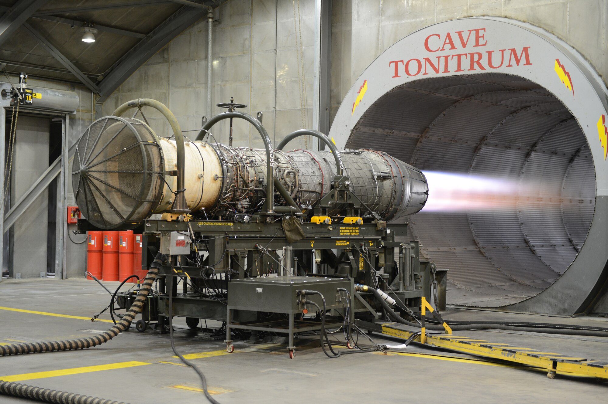 An F-16 Fighting Falcon engine operates in a hush house at Luke Air Force Base. Jet engines get tested in the hush house after undergoing heavy maintenance. These tests run jet engines through various speeds to ensure they are ready for reintegration back into the fleet. 