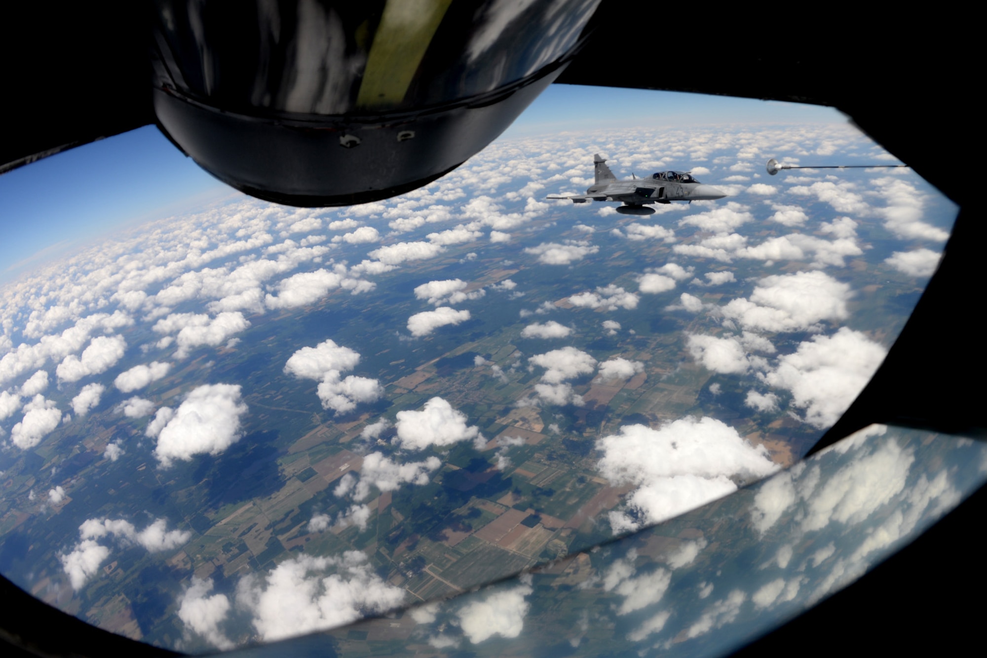 A Hungarian air force JAS-39 Gripen approaches a multi-point refueling system basket June 25, 2015, during air refueling familiarization training over Hungary. Hungarian, U.S. and Swedish air force personnel met for a two-week familiarization period enabling the Hungarian JAS-39 Gripen pilots to successfully perform air refueling for the first time. (U.S. Air Force photo by Senior Airman Kate Thornton/Released)