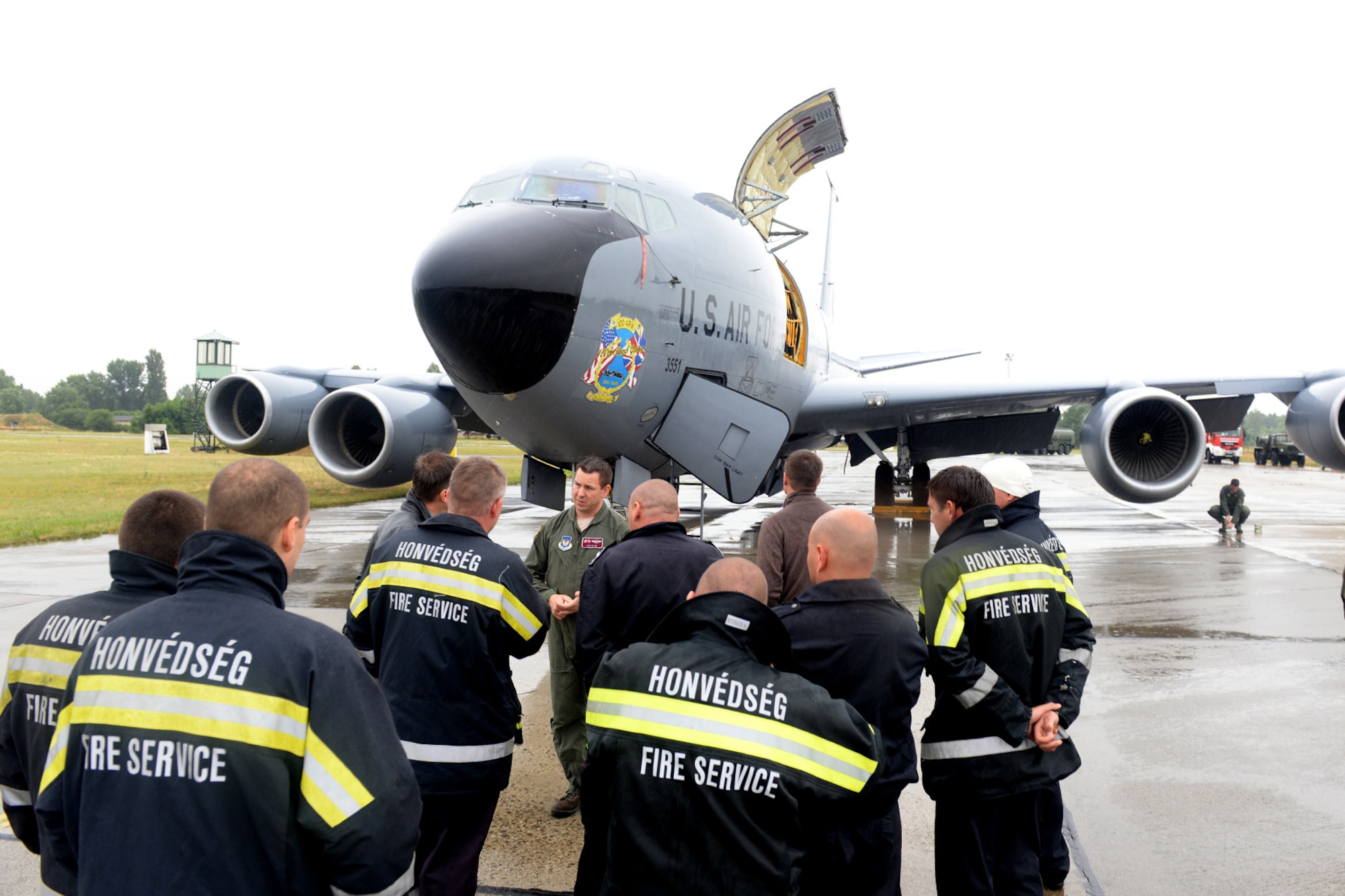 U.S. Air Force Maj. Benjamin Kline, center, 100th Air Refueling Wing KC-135 Stratotanker pilot and command post chief from Taylor, Mich., briefs Hungarian air force firefighters on the aircraft’s safety procedures June 24, 2015, during air refueling familiarization training on Kecskemét air base, Hungary. Hungarian, U.S. and Swedish air force personnel met for a two-week familiarization period enabling the Hungarian JAS-39 Gripen pilots to successfully perform air refueling for the first time. (U.S. Air Force photo by Senior Airman Kate Thornton/Released)