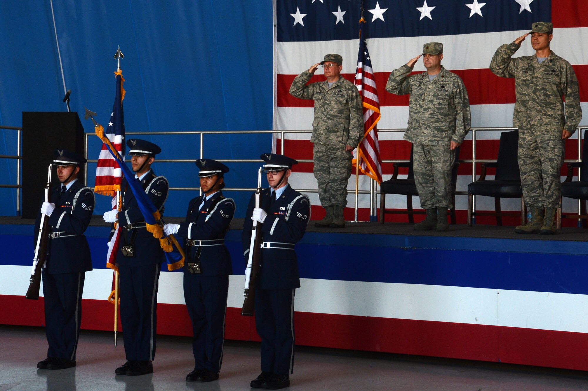 20th Maintenance Group officers salute the flag during the playing of the national anthem at the 20th Aircraft Maintenance Squadron change of command ceremony at Shaw Air Force Base, S.C., July 10, 2015. The change of command ceremony traces its beginnings to 18th century Prussia during the reign of King Frederick the Great. (U.S. Air Force photo by Senior Airman Jonathan Bass/Released)