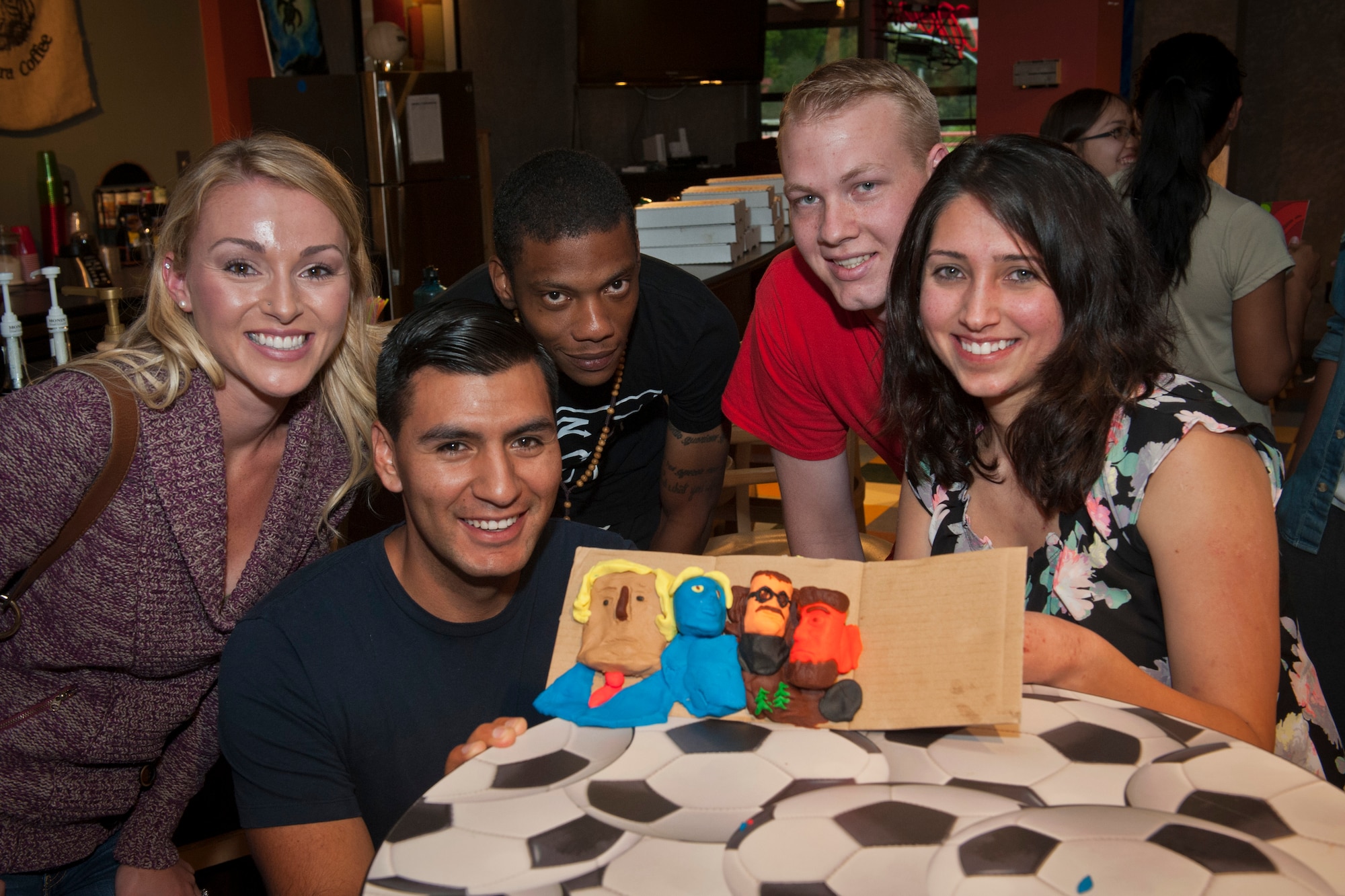 PETERSON AIR FORCE BASE, Colo. –  21st Dental Squadron dental lab technicians use their skilled hands to recreate a modeling clay version of Mount Rushmore during the first ever Mount Rushmore building competition at the Eclipse Cyber Café, July 8, 2015. Airmen were given a half hour to complete their best sculptures using only their hands and the tools provided by the chapel. The 21st DS Airmen received first place out of four teams. (U.S. Air Force photo by Airman 1st Class Rose Gudex)